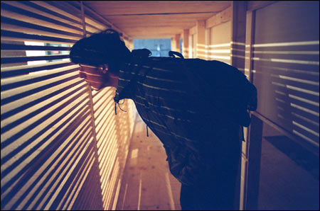 Parlato peering through slats of inner