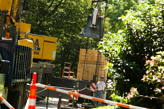 A giant crane lifts the new bell from its crate. 