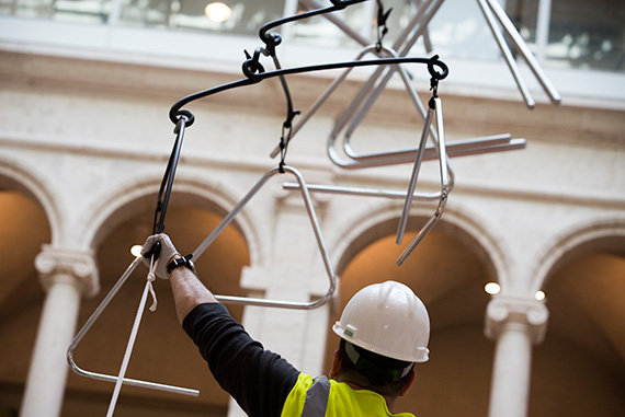 Collections Specialist Sean Lunsford lends a hand during the installation. According to Amorales, the Harvard piece is more “about the idea of sound than how it sounds.”