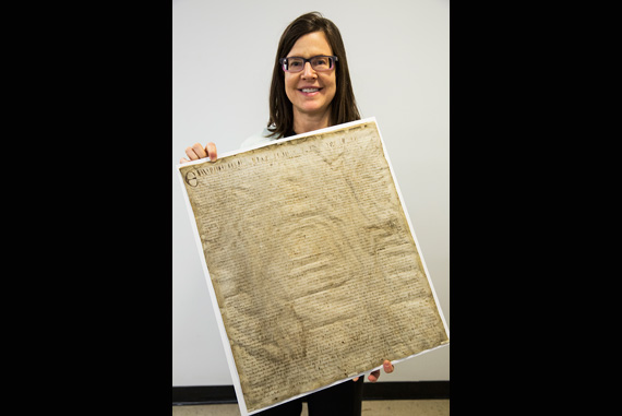 Karen Beck, manager of historical and special collections at the Harvard Law School (HLS) Library, holds a sheriff’s copy of an abbreviated Magna Carta, circa 1327. According to Beck, the document would have been read aloud four times a year in the town square. “This is my favorite Magna Carta of all,” said Beck, “because you can really see how it was used.” The HLS Library has a large collection of manuscript copies of the famous political text, which is celebrating its 800th anniversary. Unlike the sheriff’s copy, most versions of the HLS Magna Cartas are contained in early English statutory compilations dating from about 1300 to 1500. Photos by Jon Chase/Harvard Staff Photographer