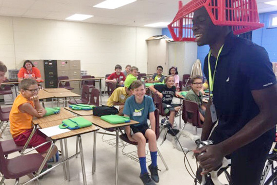 June 15: Tola Omilana '16 clowns around with Lexington, Ky., schoolchildren during one of the team’s teaching stops. The group presented a dozen “learning festivals” on robotics, computer science, and rocketry as a way to engage youngsters in science, technology, engineering, and math. Photos courtesy of Francesca Childs