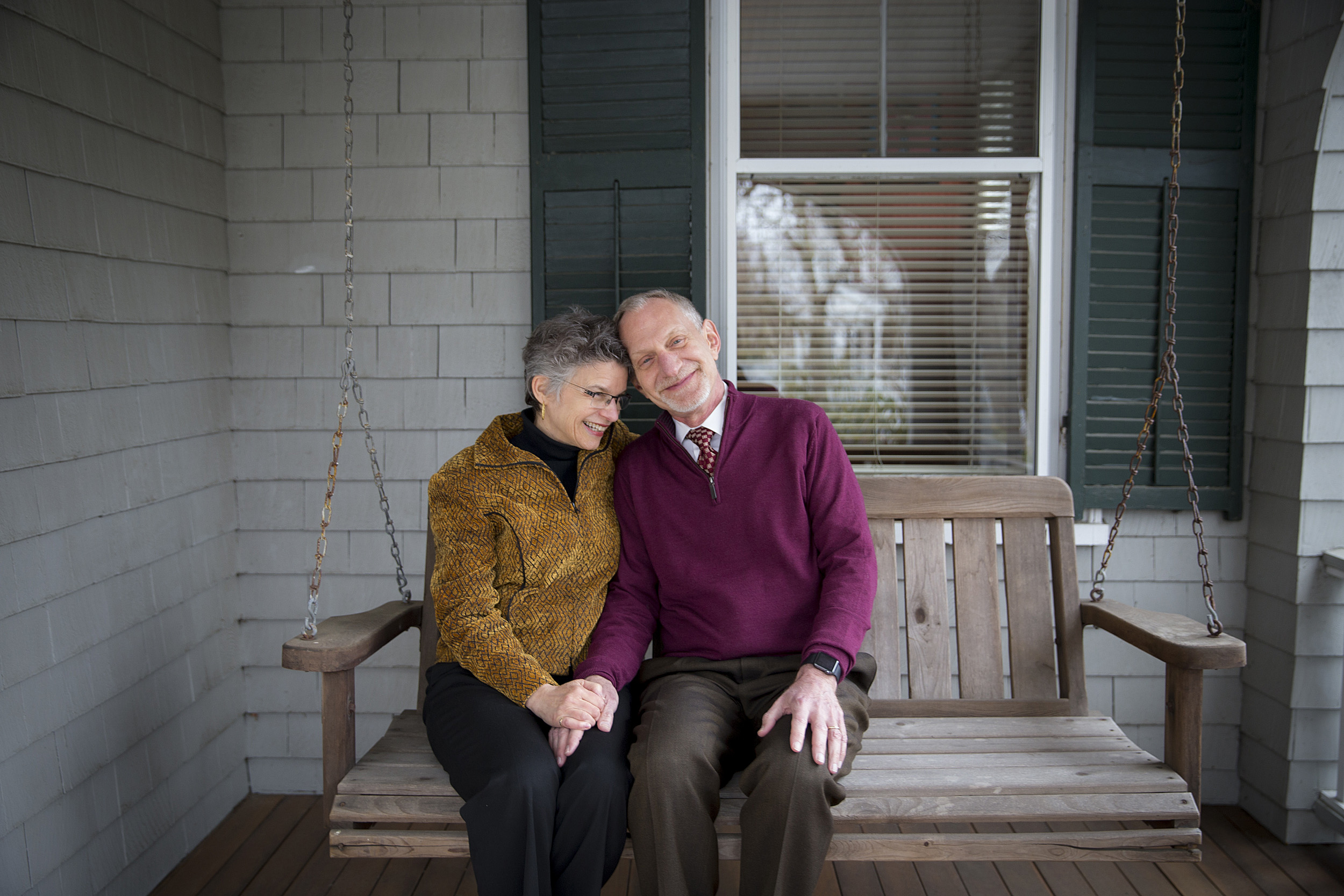 Robert Waldinger, who directed one of the world’s longest studies of adult life, sits with his wife on a swing.