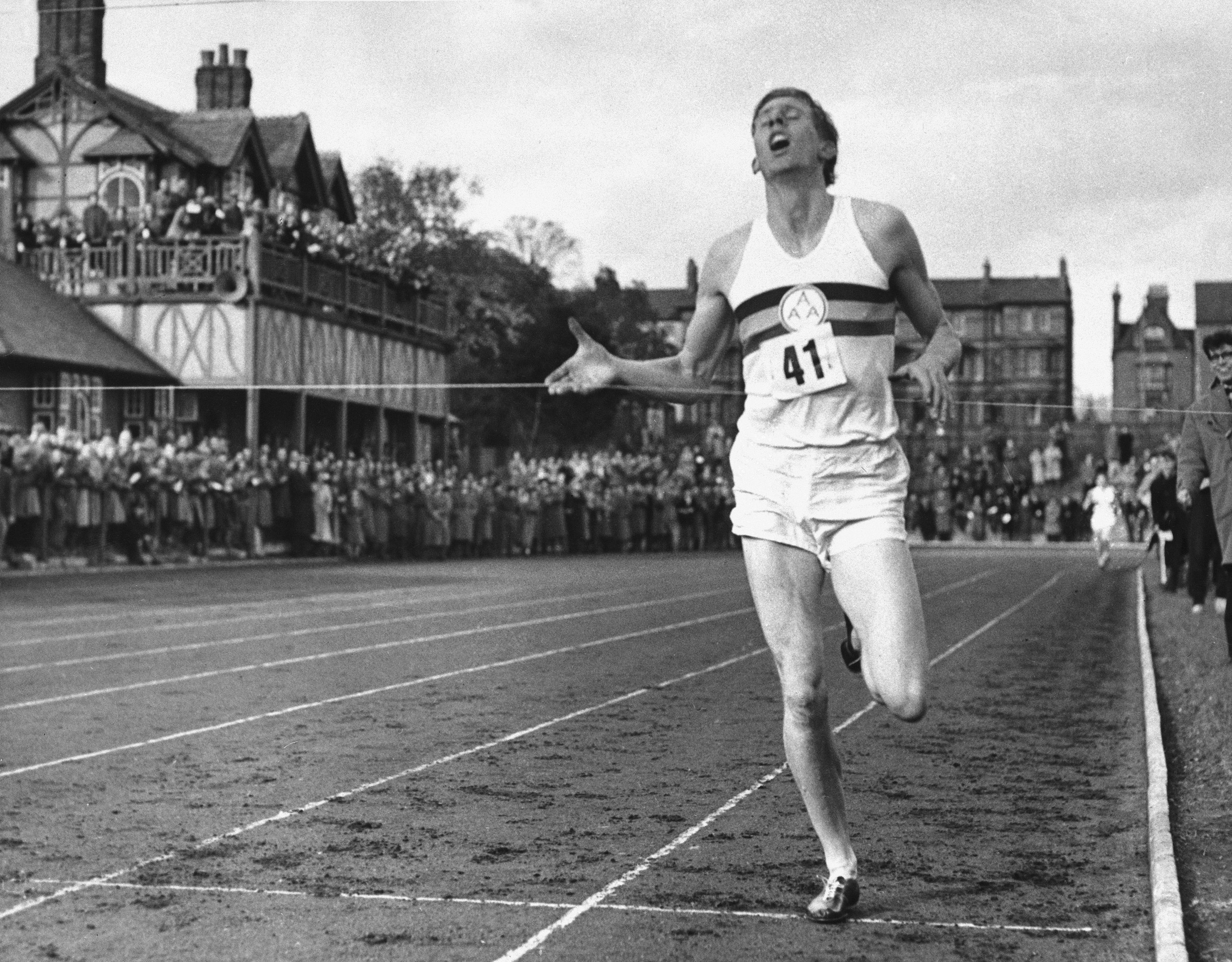 Runner Roger Bannister breaks the tape.