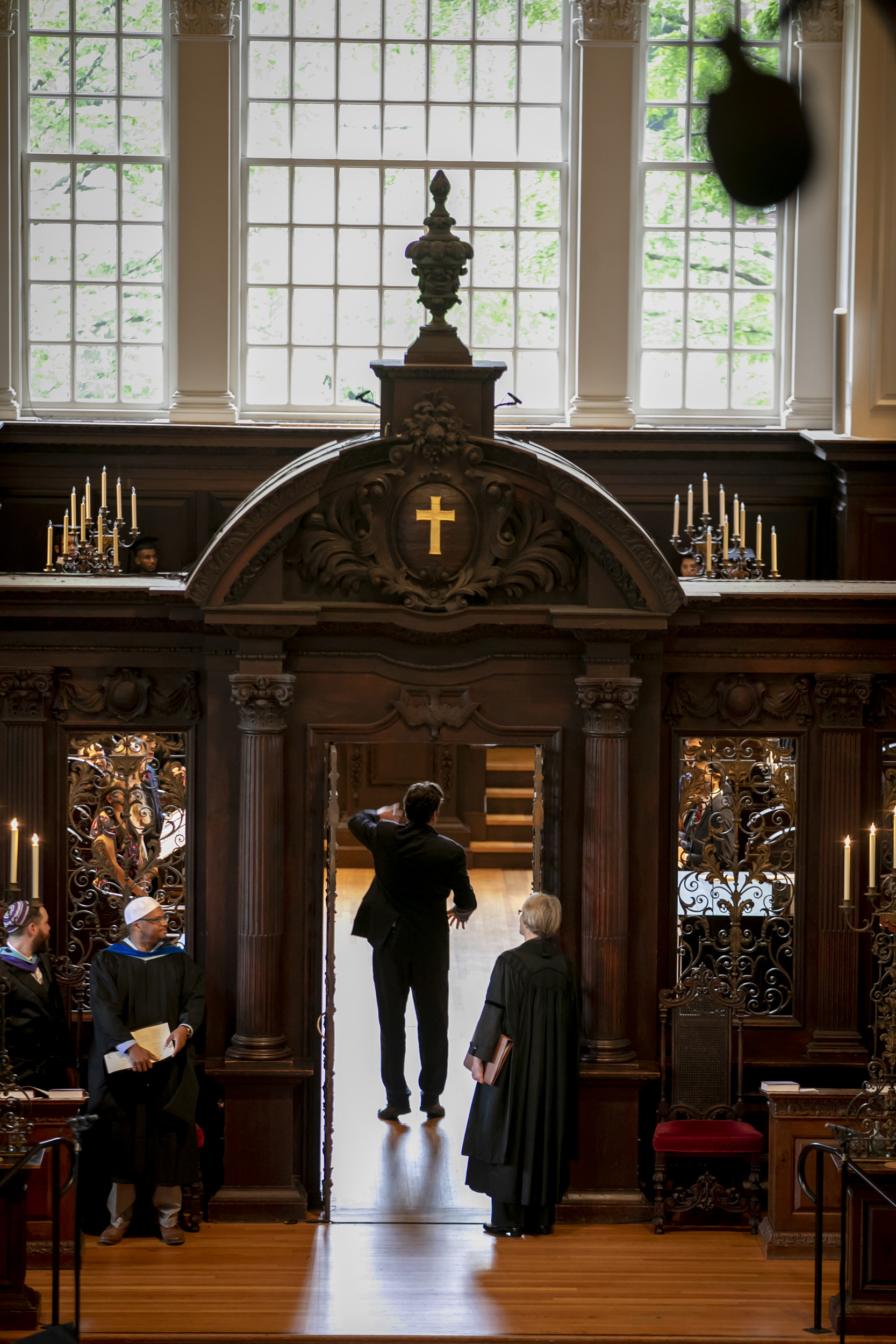 Drew Faust stands to watch choir.