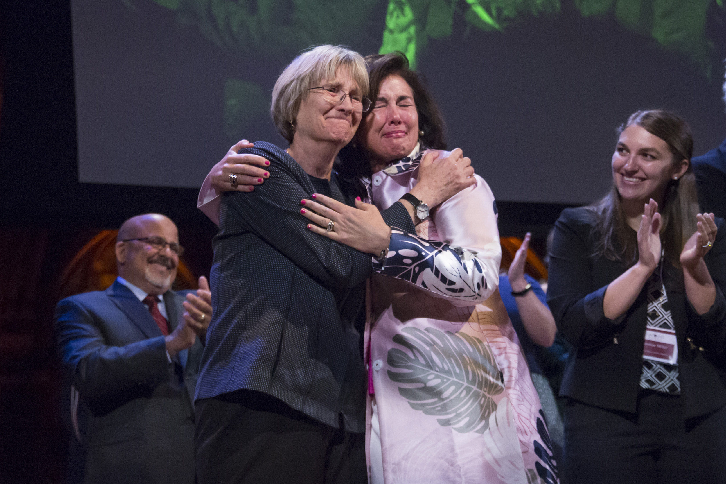 Drew Faust and Trearty Bartley hug.