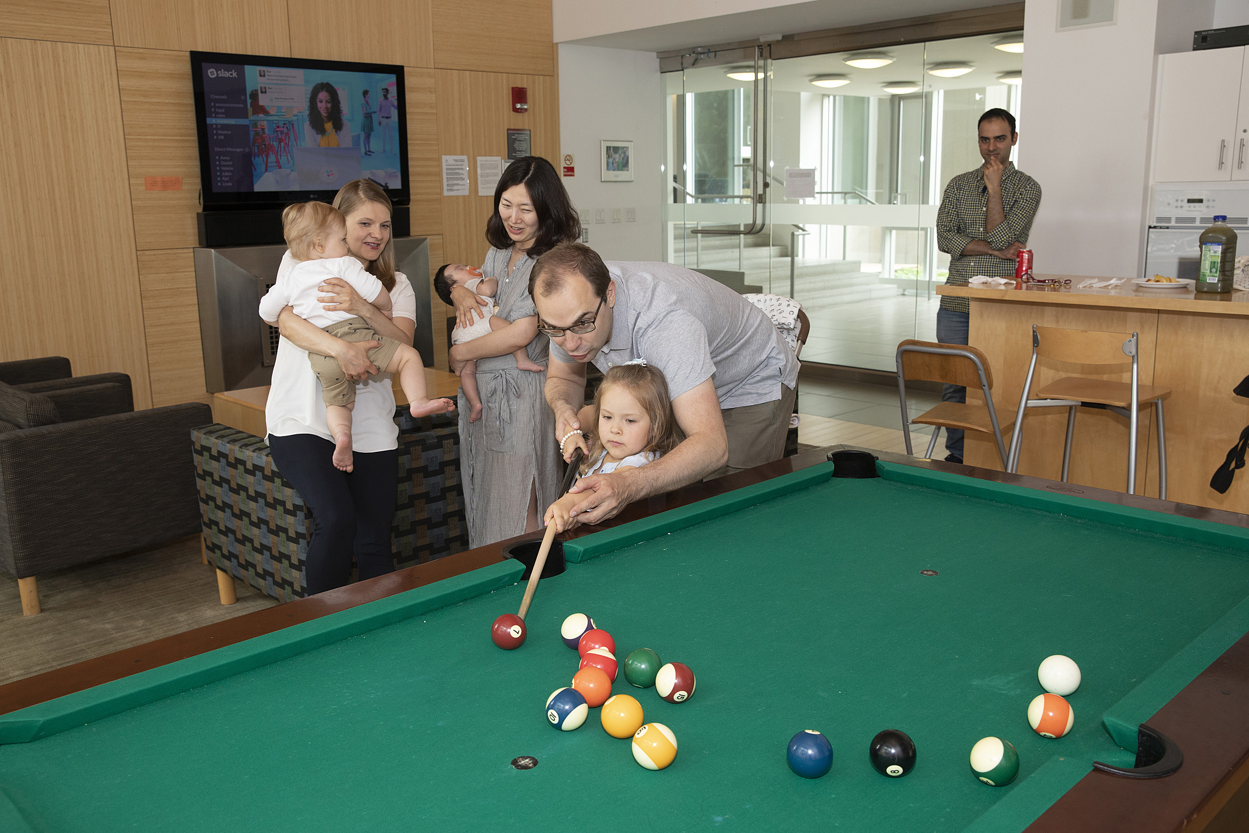 family playing pool at grad commons