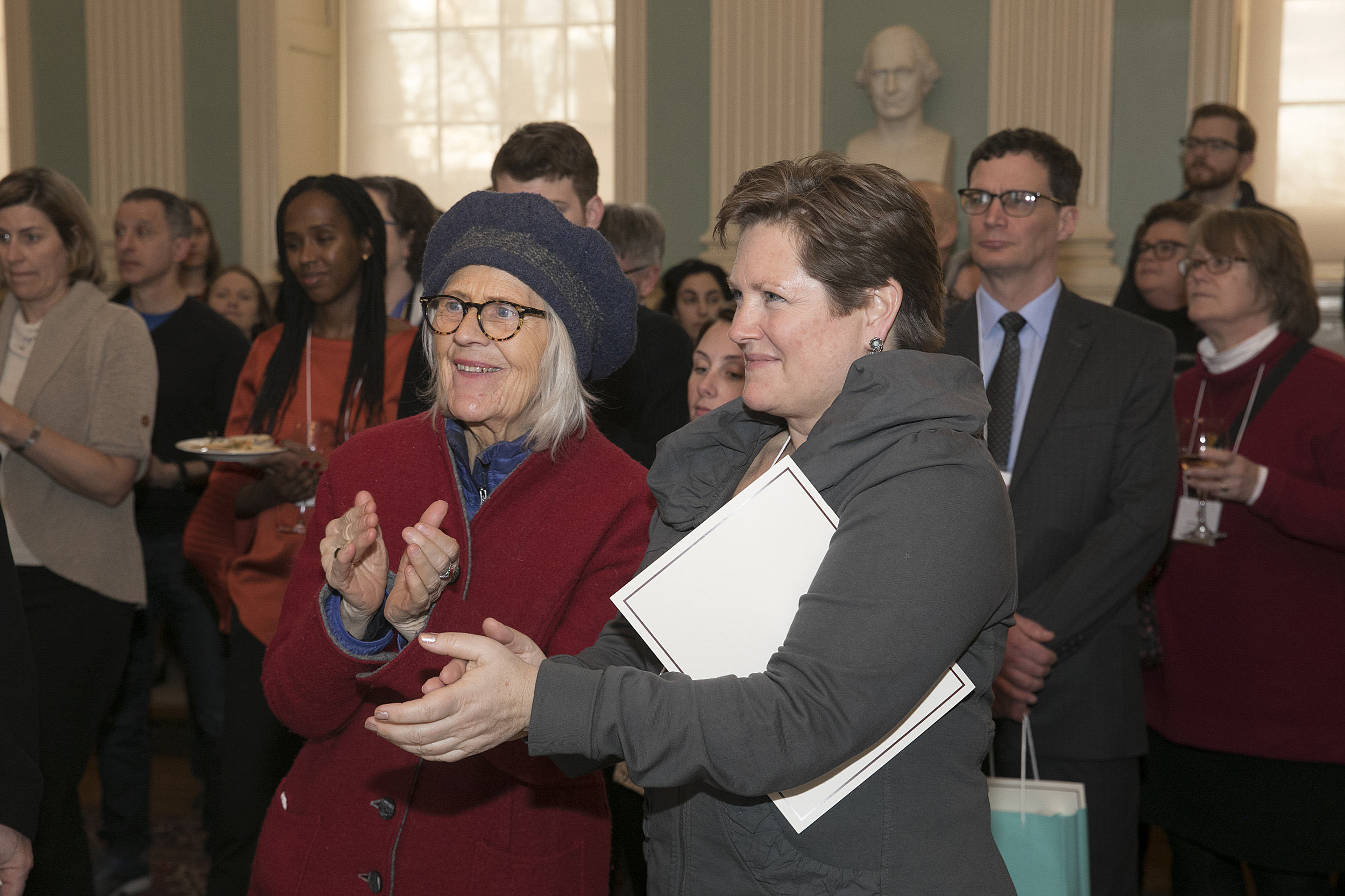 Two women applauding