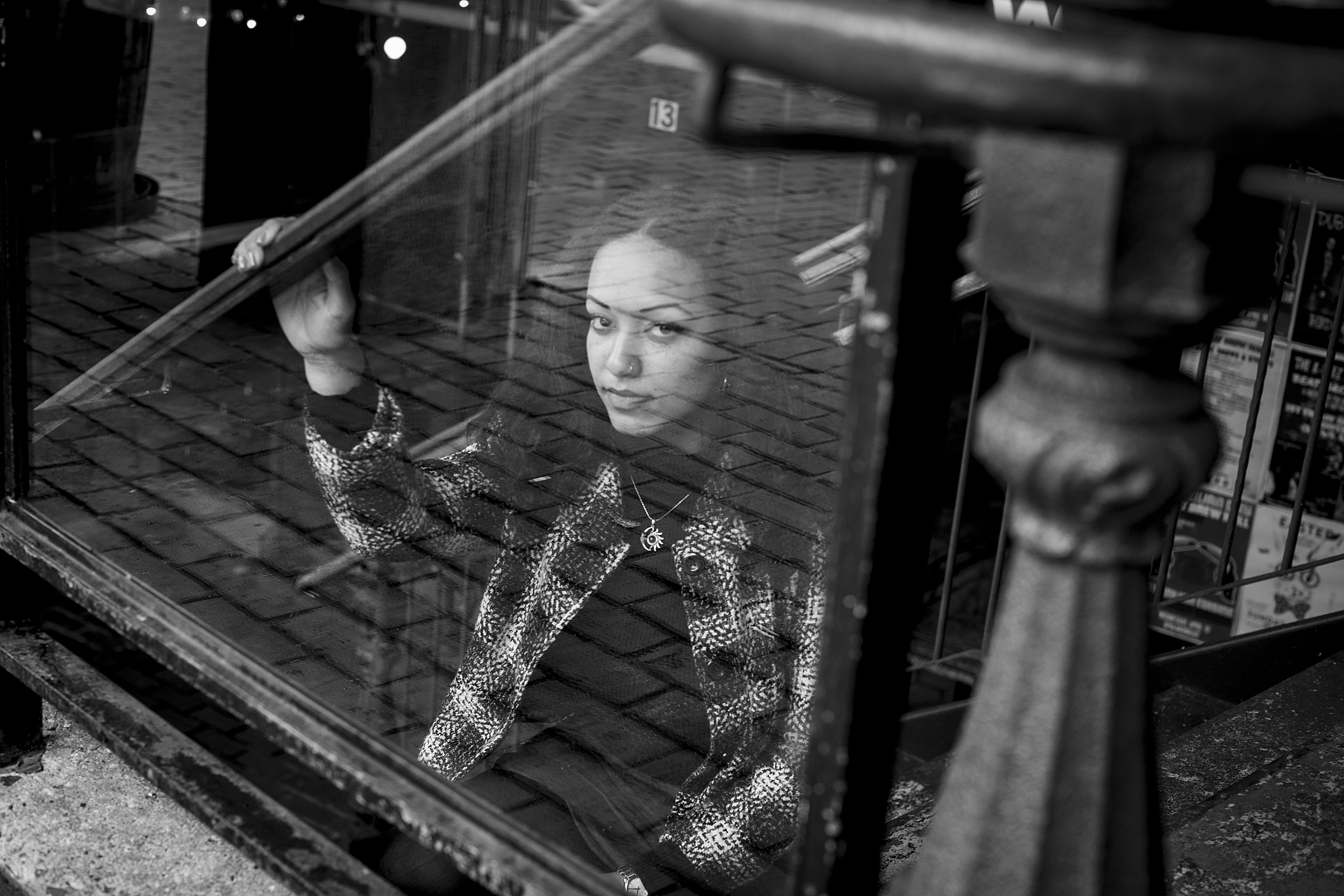 Dominique Erney looking up from behind glass