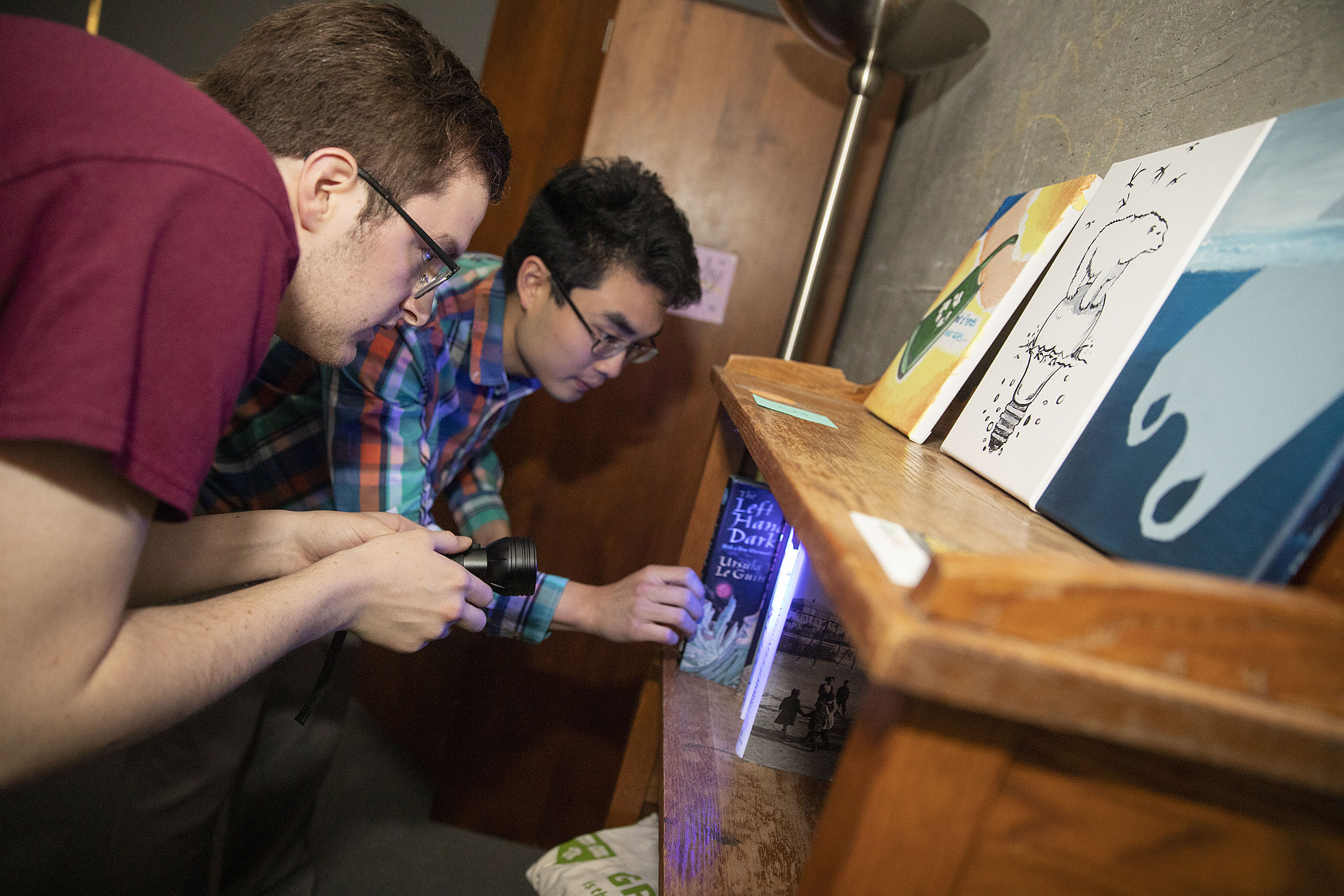 Tyler Morris and Michael Cheng look for clues.