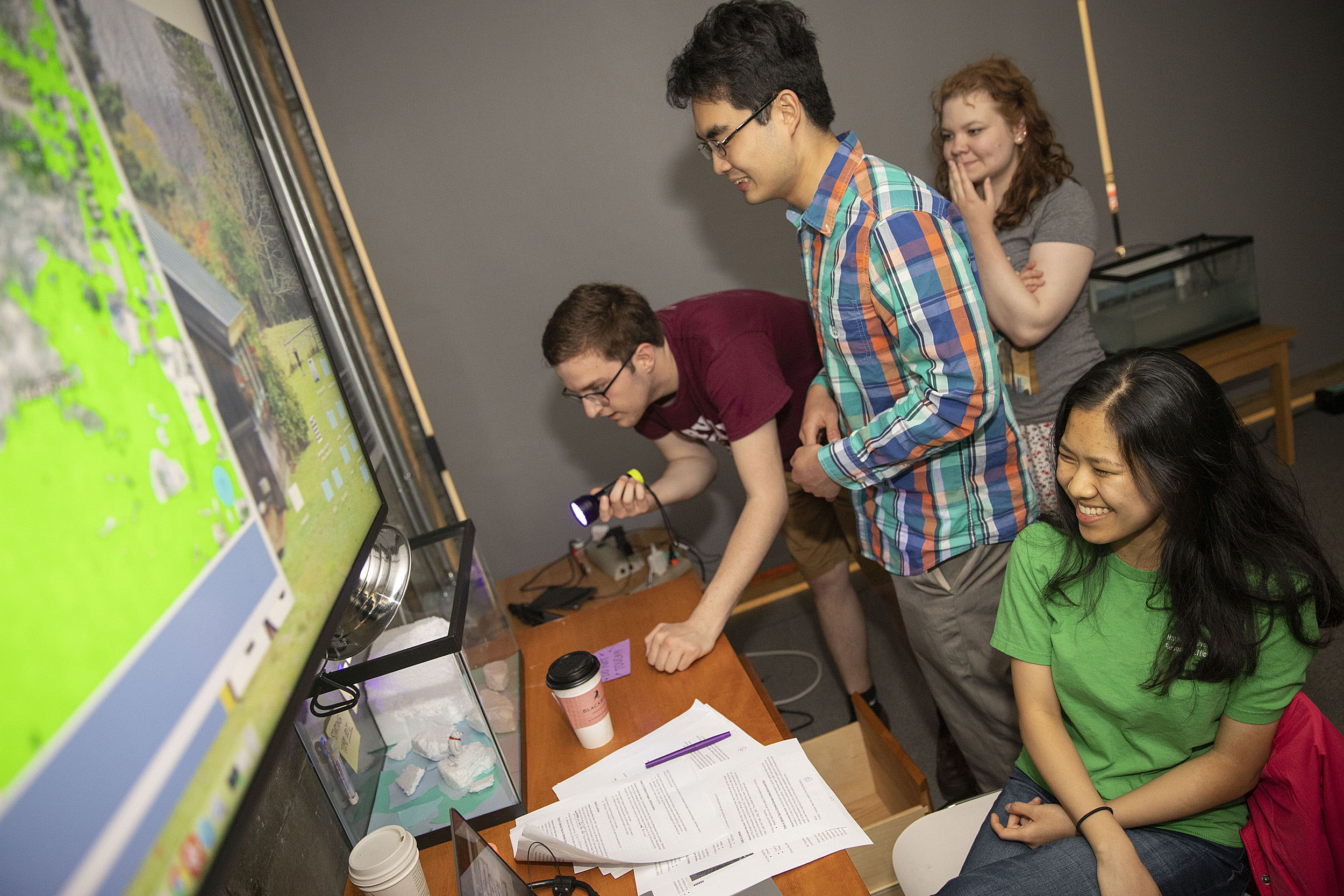 Room guide Beverly Ge gives clues to "escape room" participants Tyler Morris, Michael Cheng, and Jena Lorman.