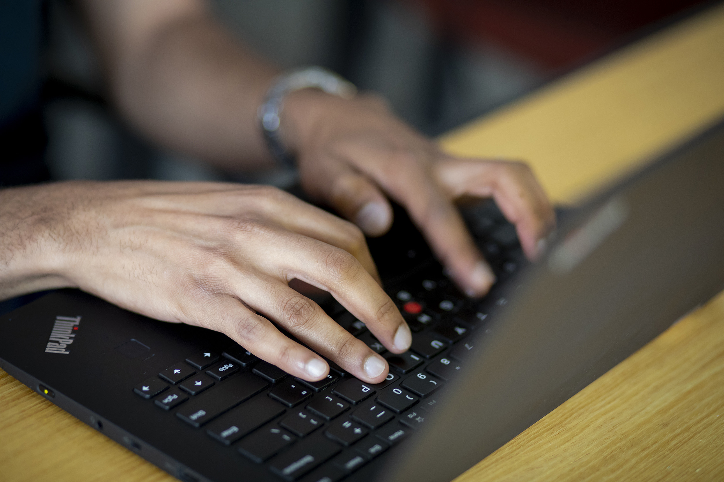 Hands typing on a keyboard