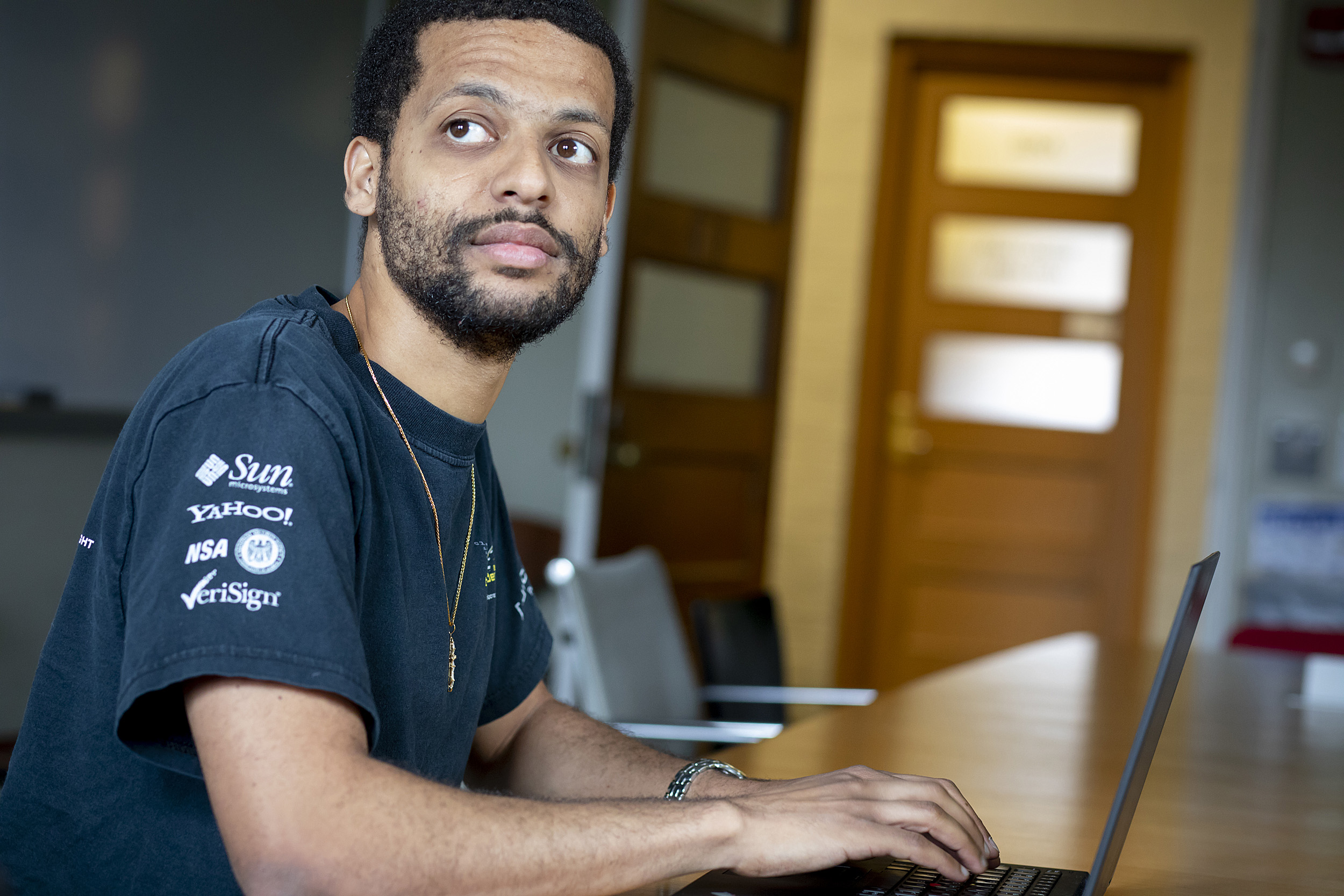 Jelani Nelson sitting in front of a laptop