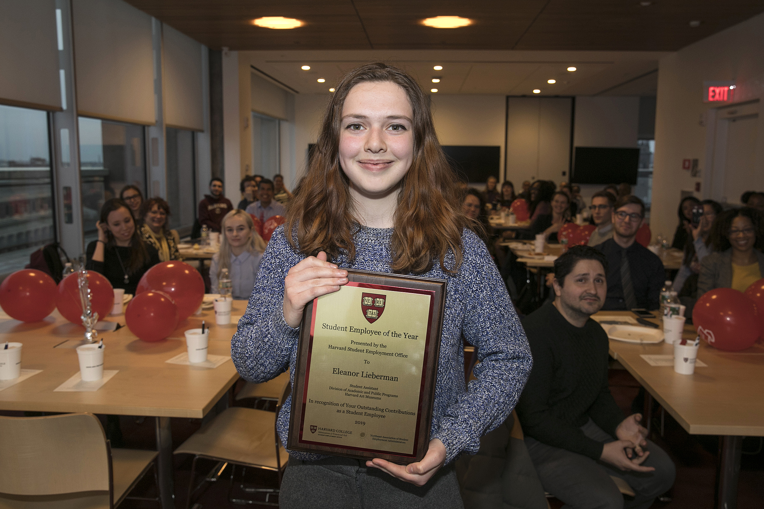 Eleanor Lieberman holds her Student Employee of the Year plaque