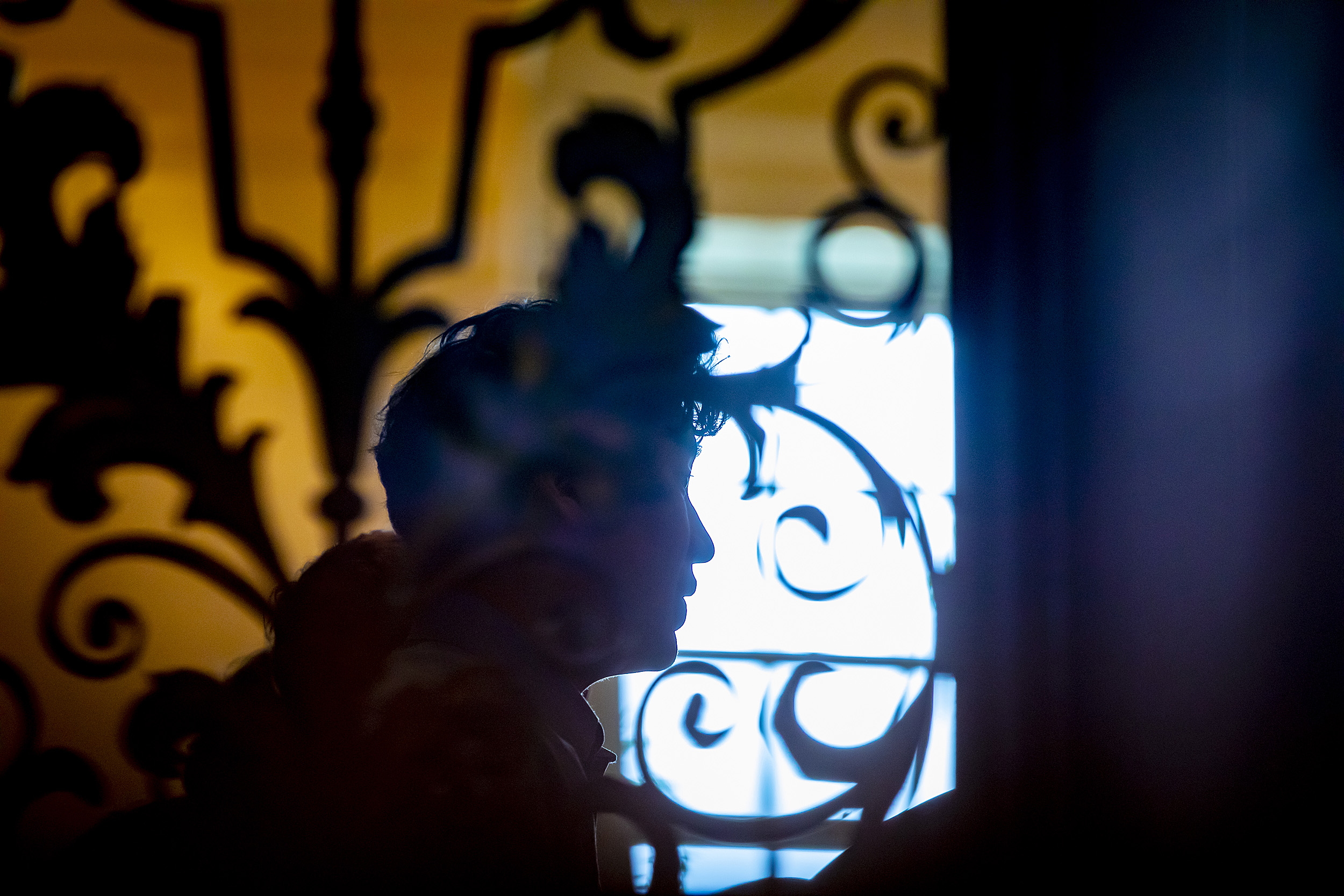 Silhouette of choir member framed by wrought iron in Memorial Church.