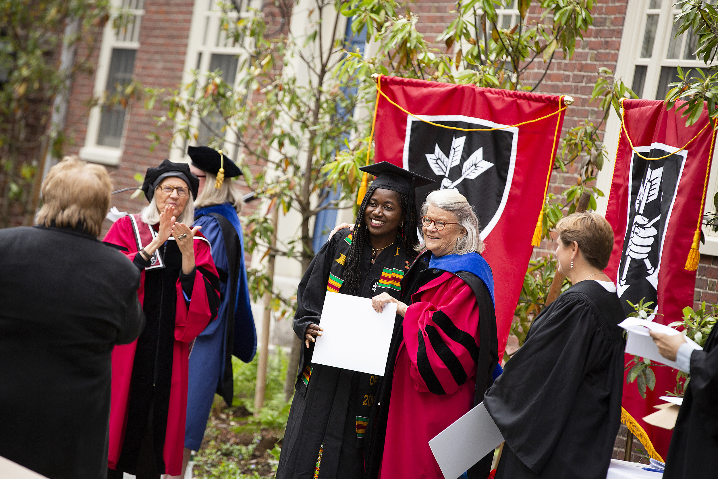 A Lowell House graduate receives her diploma.