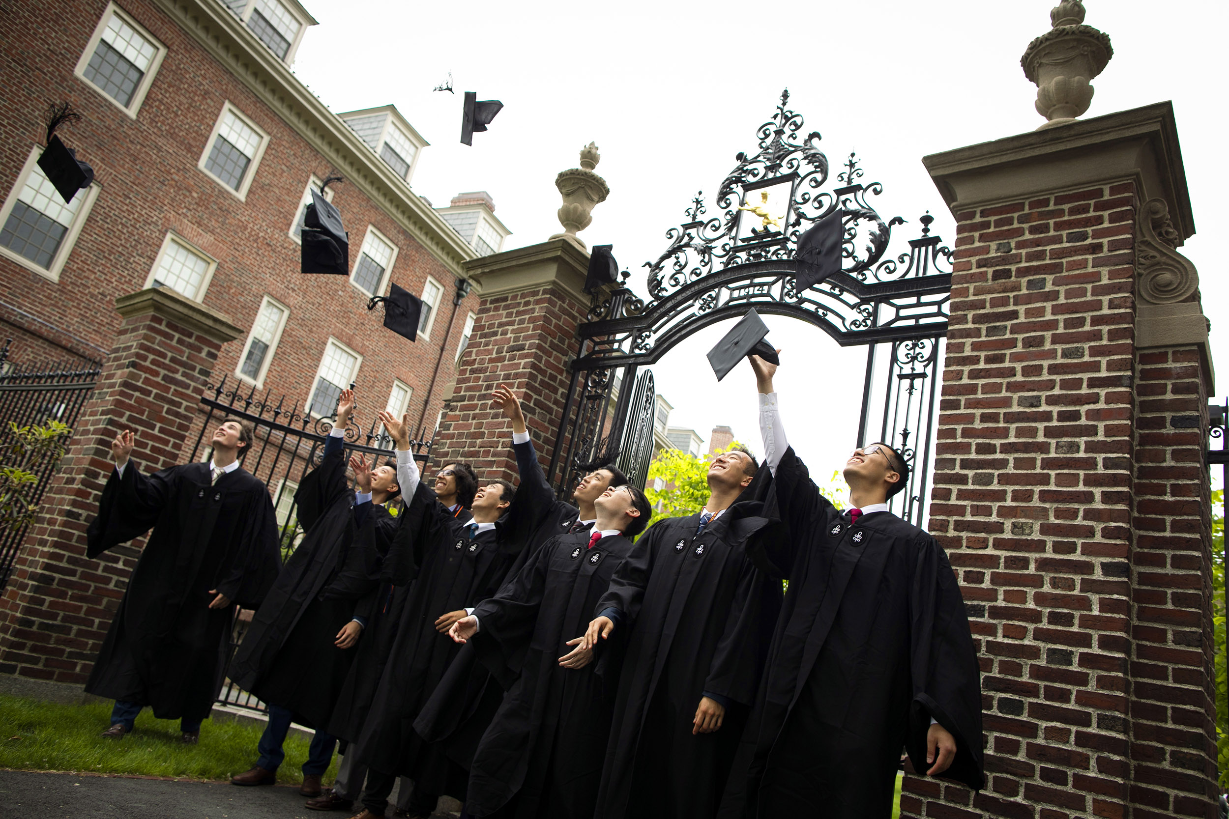 Graduates toss their caps in the air