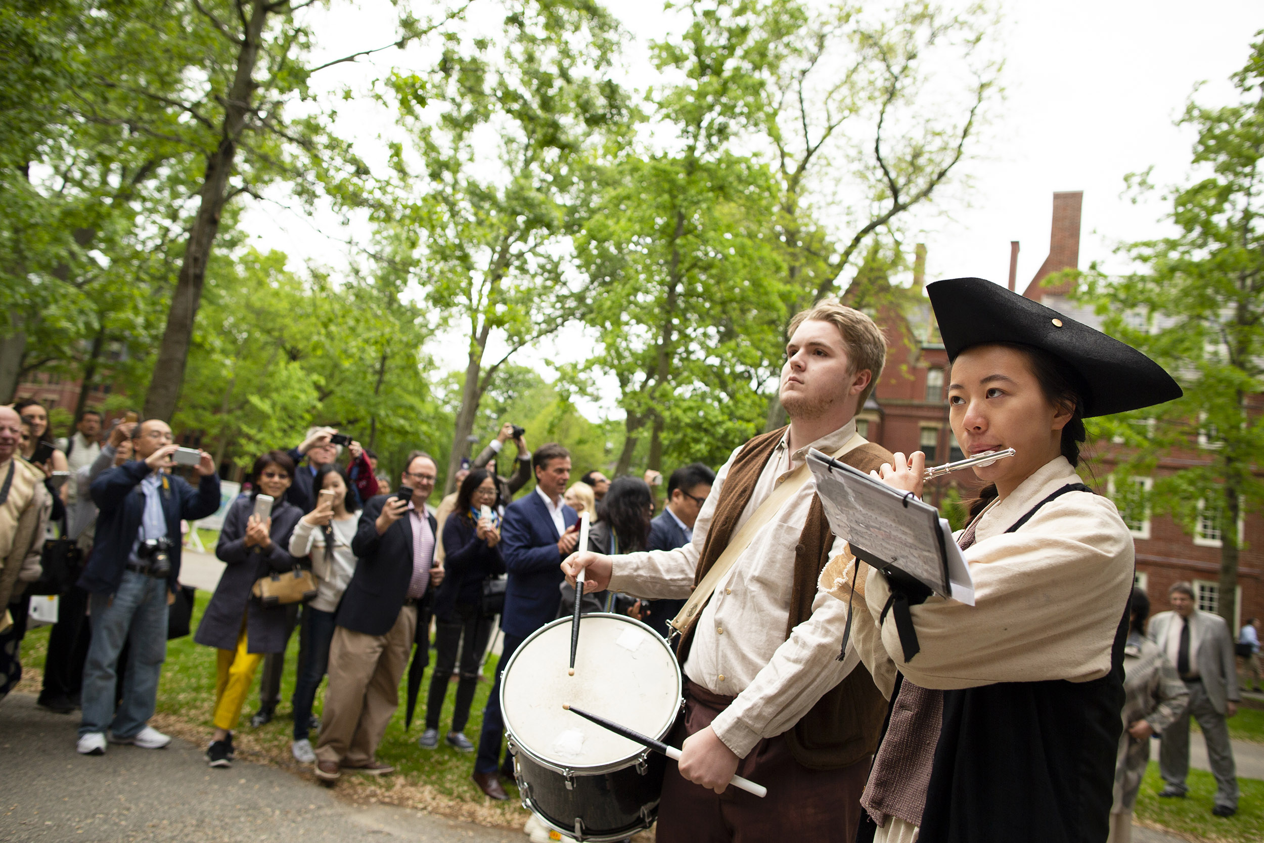 Ian Saum and Allison Law play drum and piccolo during procession.