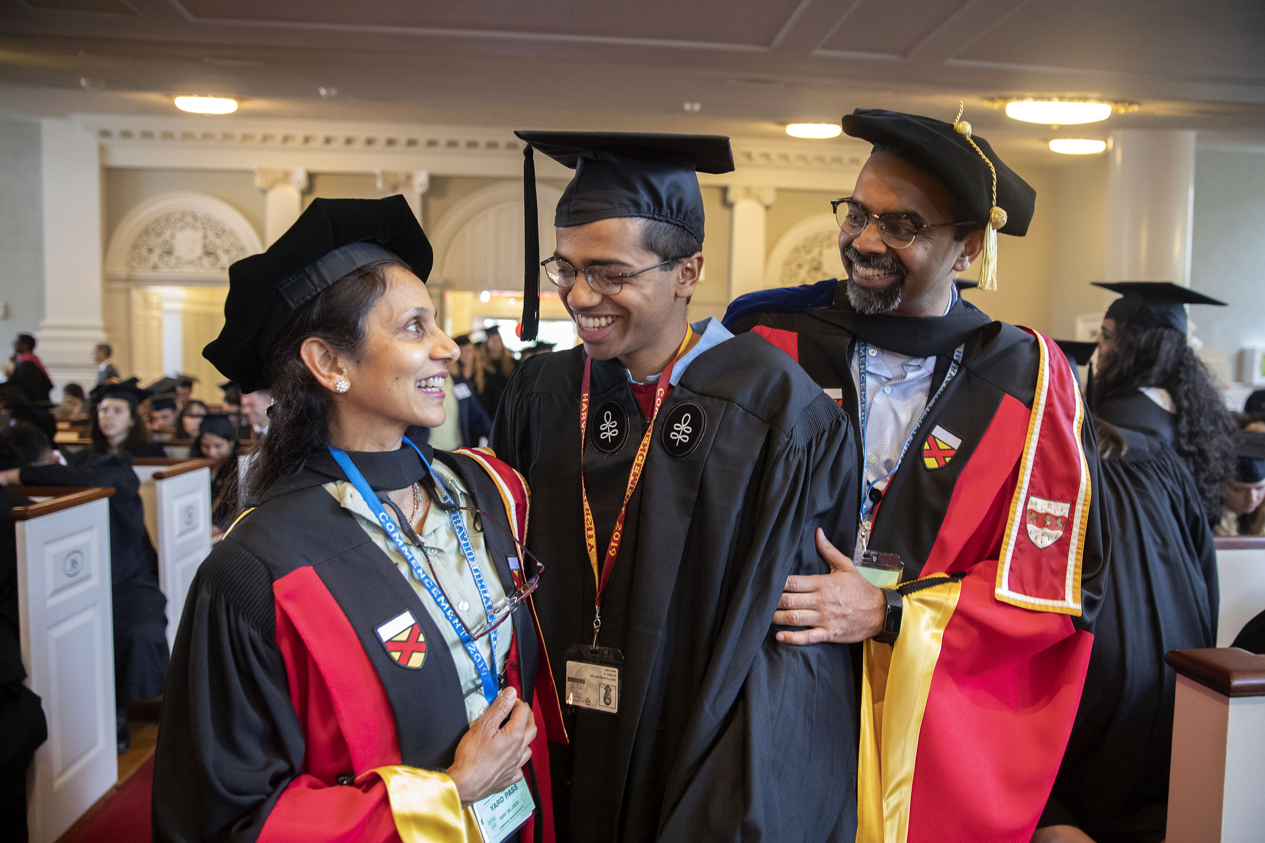 Amala and L. Mahadevan and their son Aditya Mahadevan (center) smile during the Senior Class Chapel Service in Memorial Church.