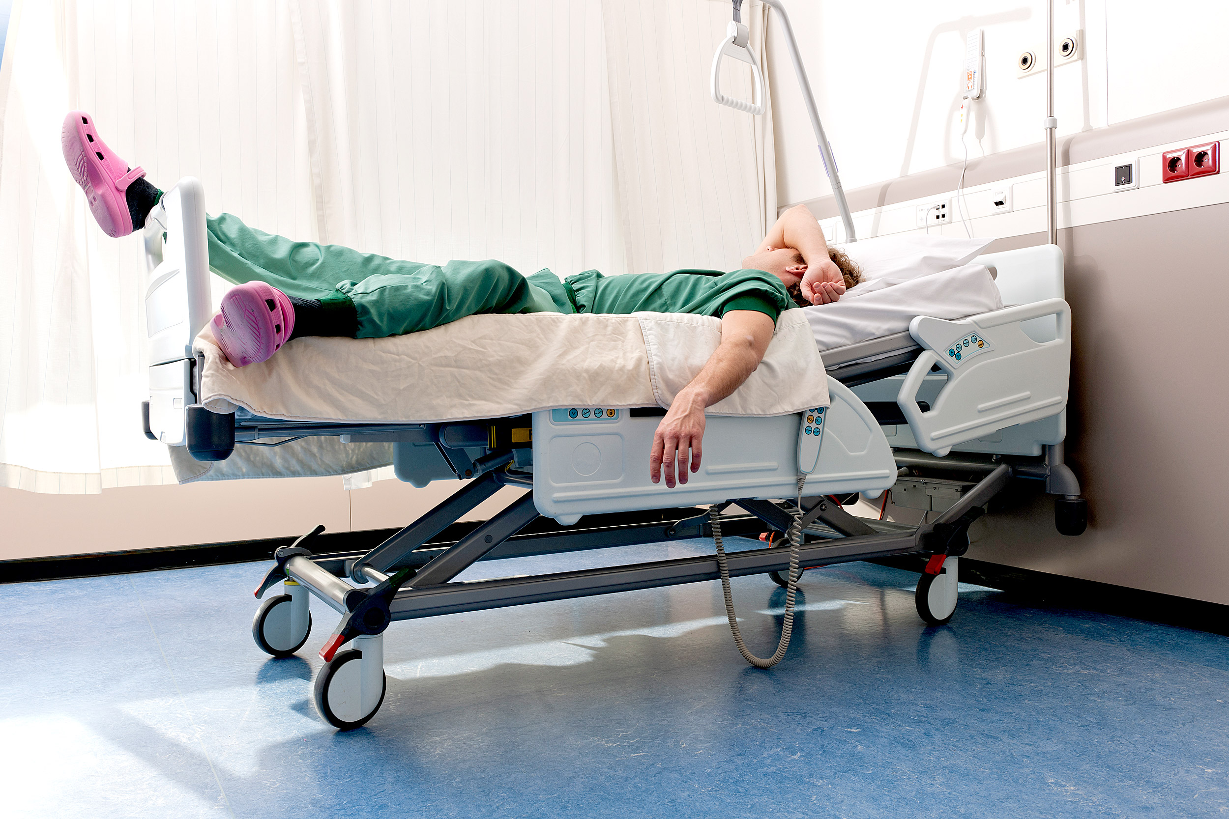 Medical resident sleeping on hospital ward