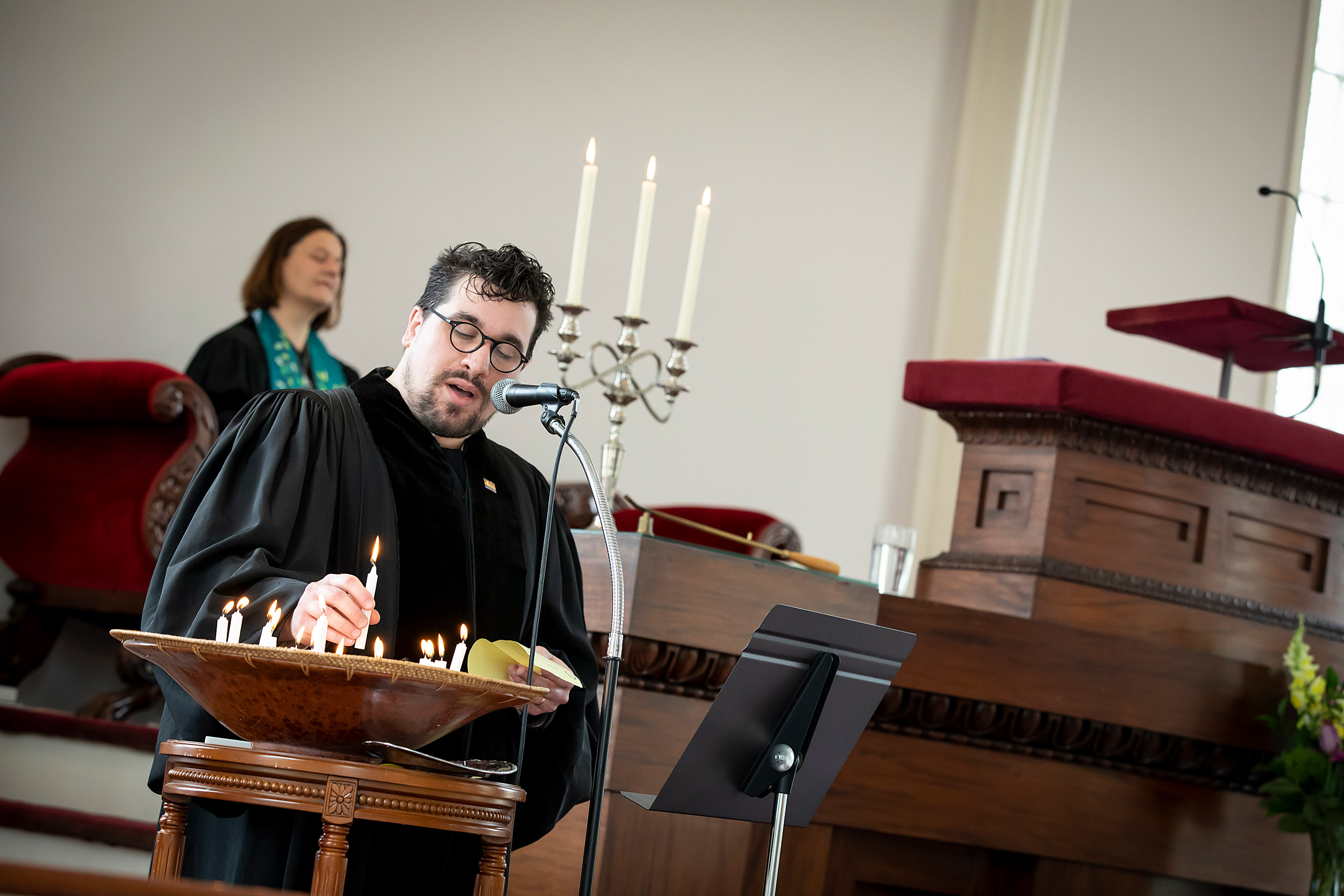 Israel Buffardi lights candles on the altar.