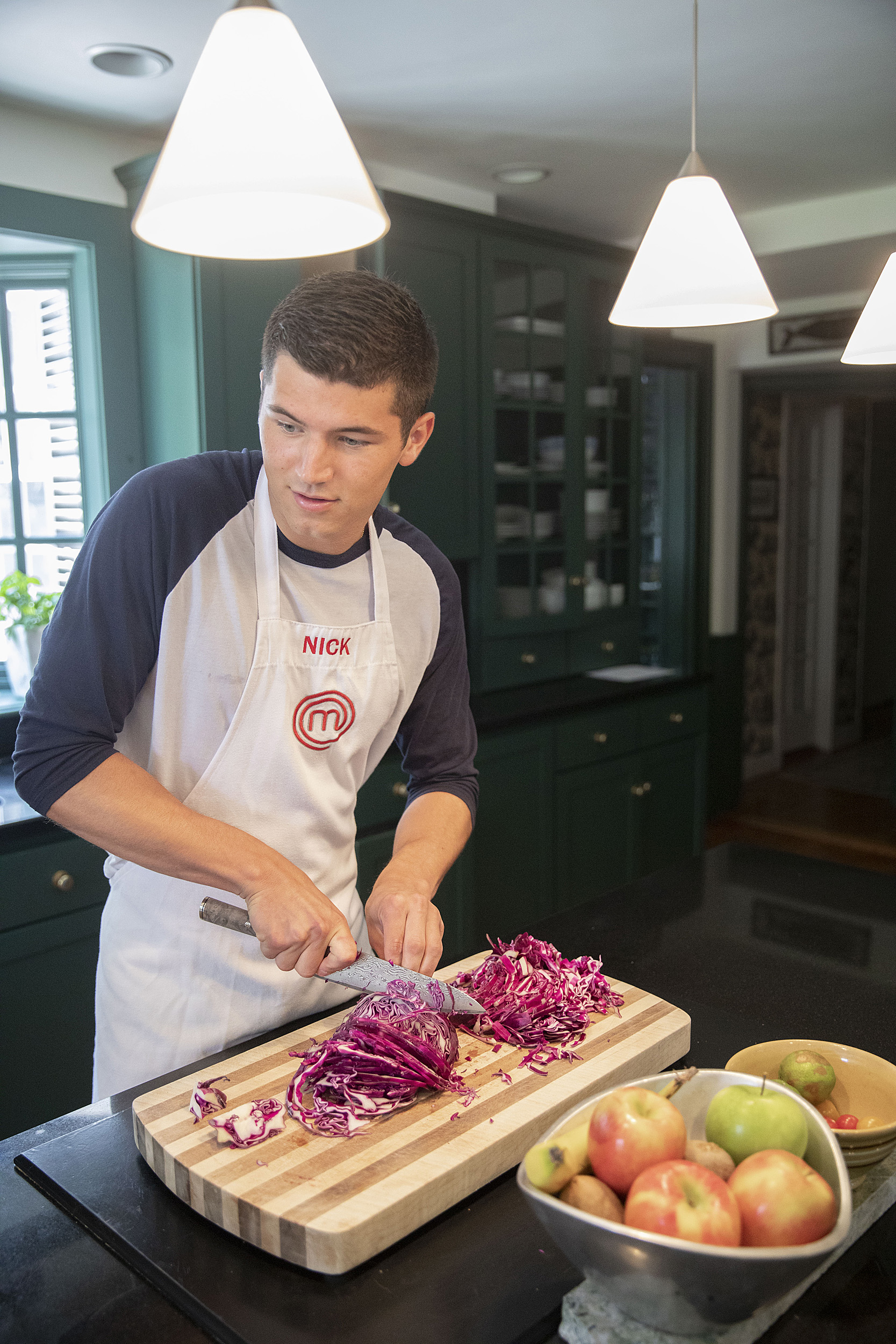 Nick DiGiovanni cooks at his home in Milton.