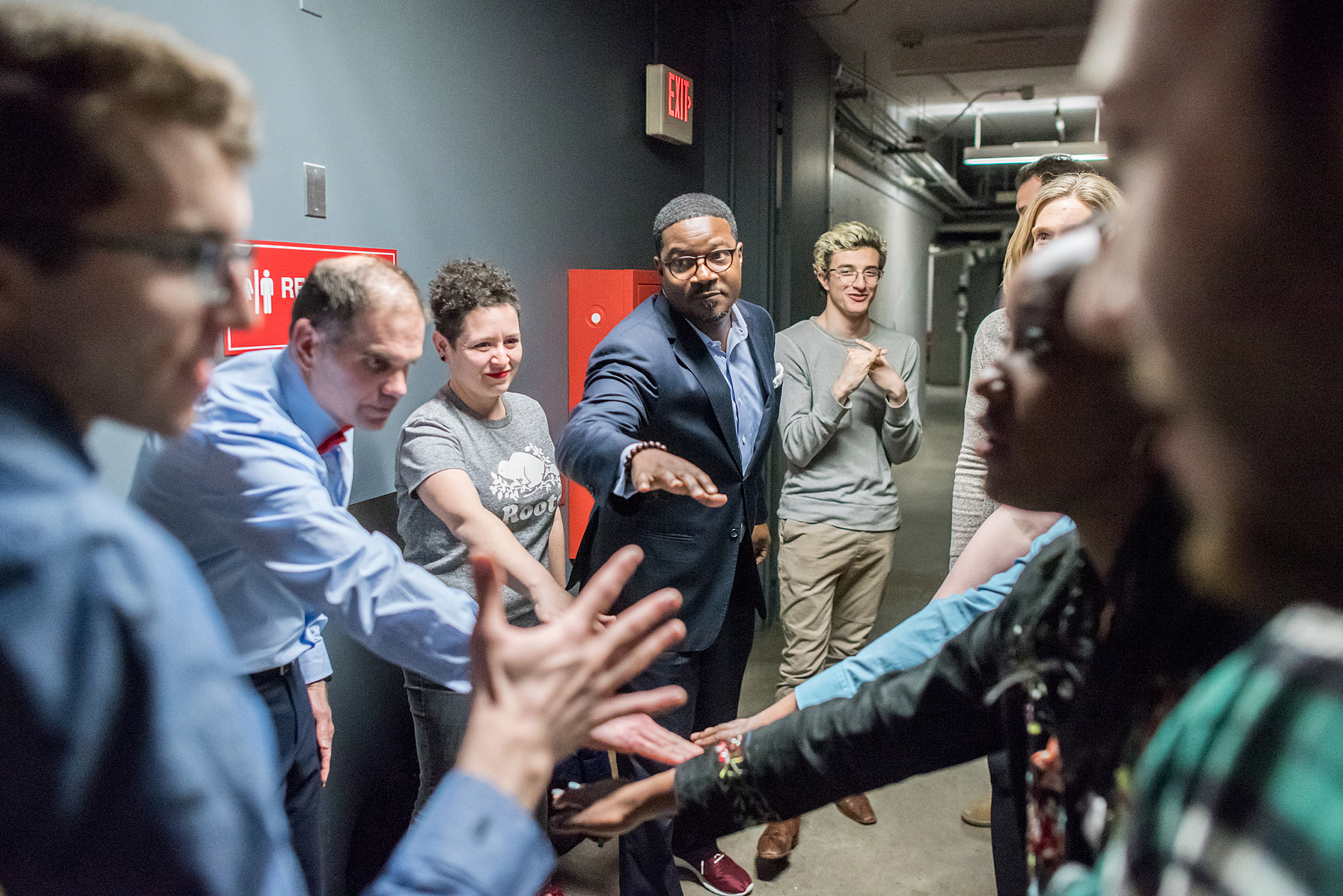 Faculty and deans huddle in support backstage.