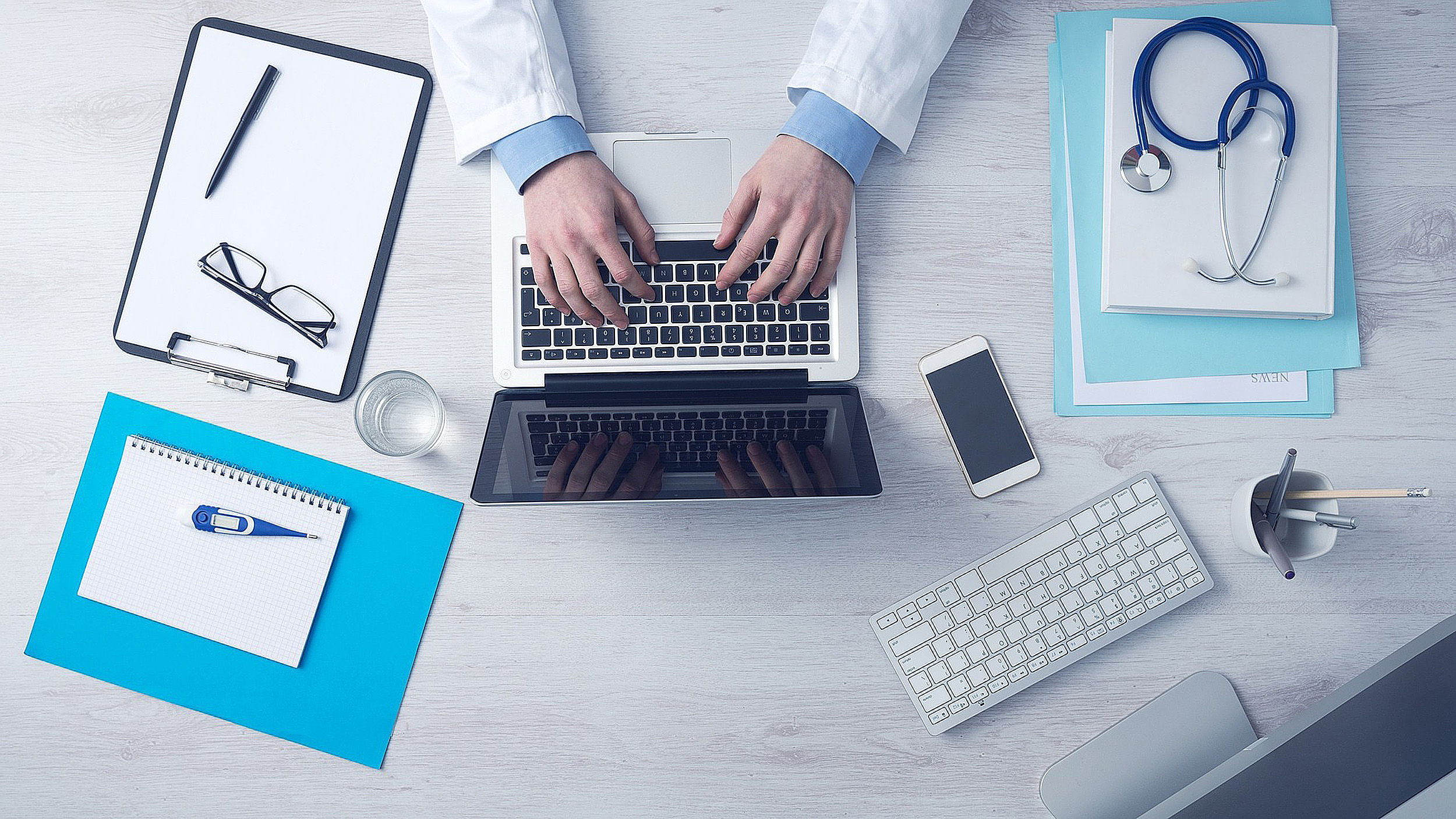 Overhead view of a doctor working on a laptop