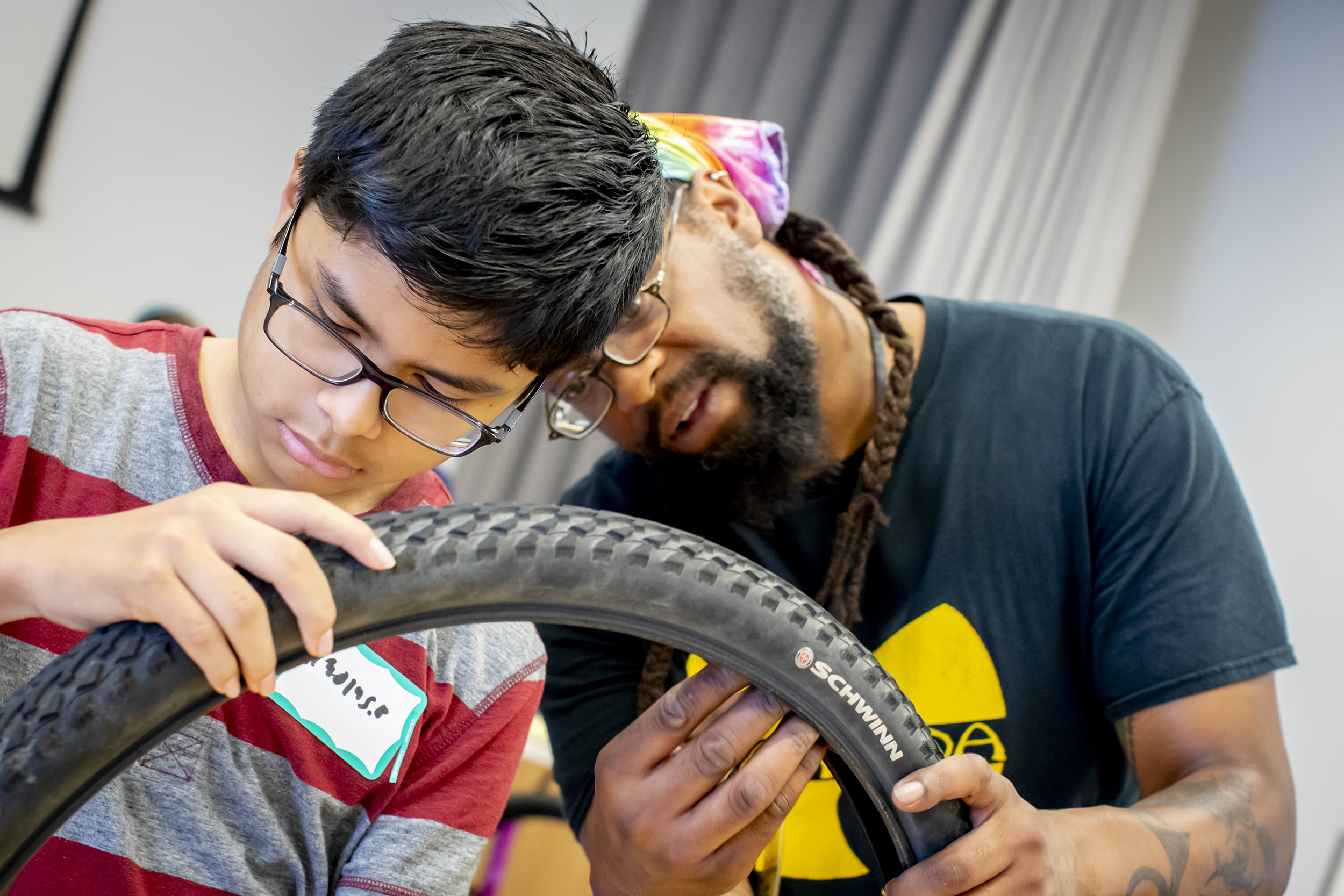 Nicolas Bautista replaces a tire with Gamal Smith.