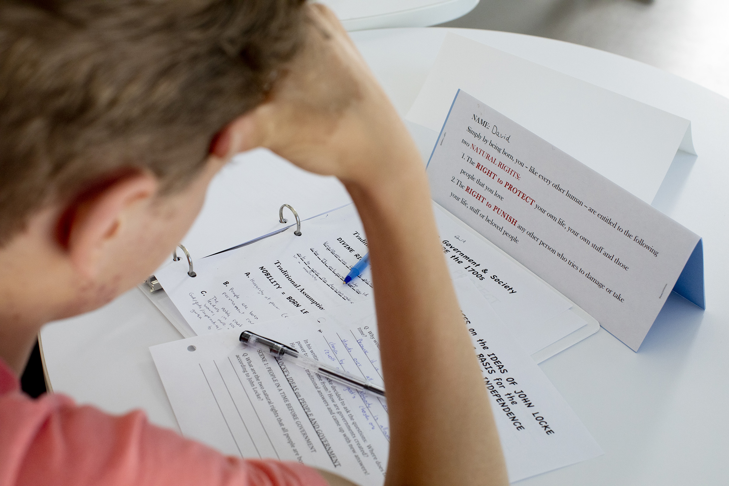 A student reads class papers.