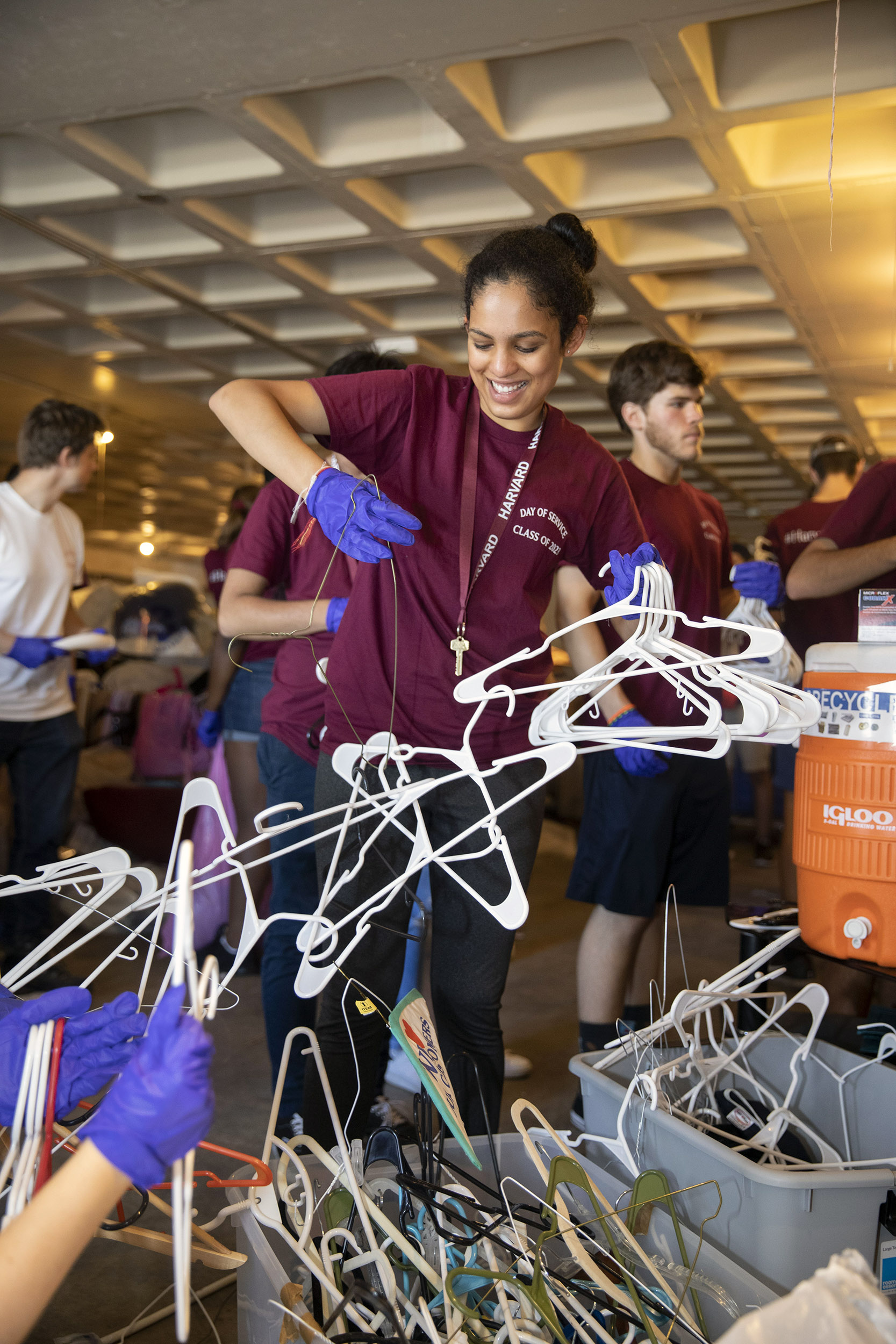 Student untangling coat hangers