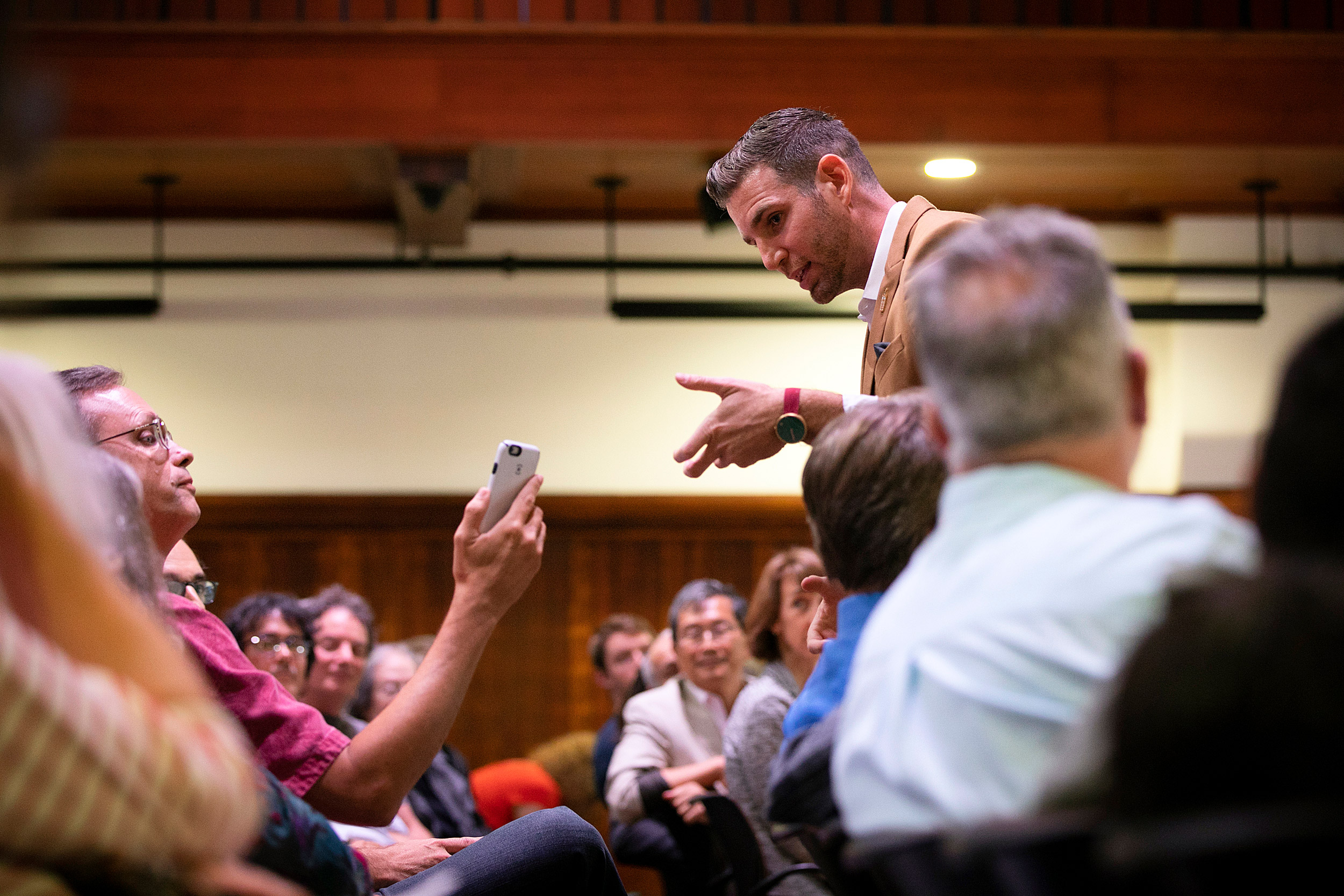 Magician Joshua Jay talks to audience members at a Radcliffe talk.