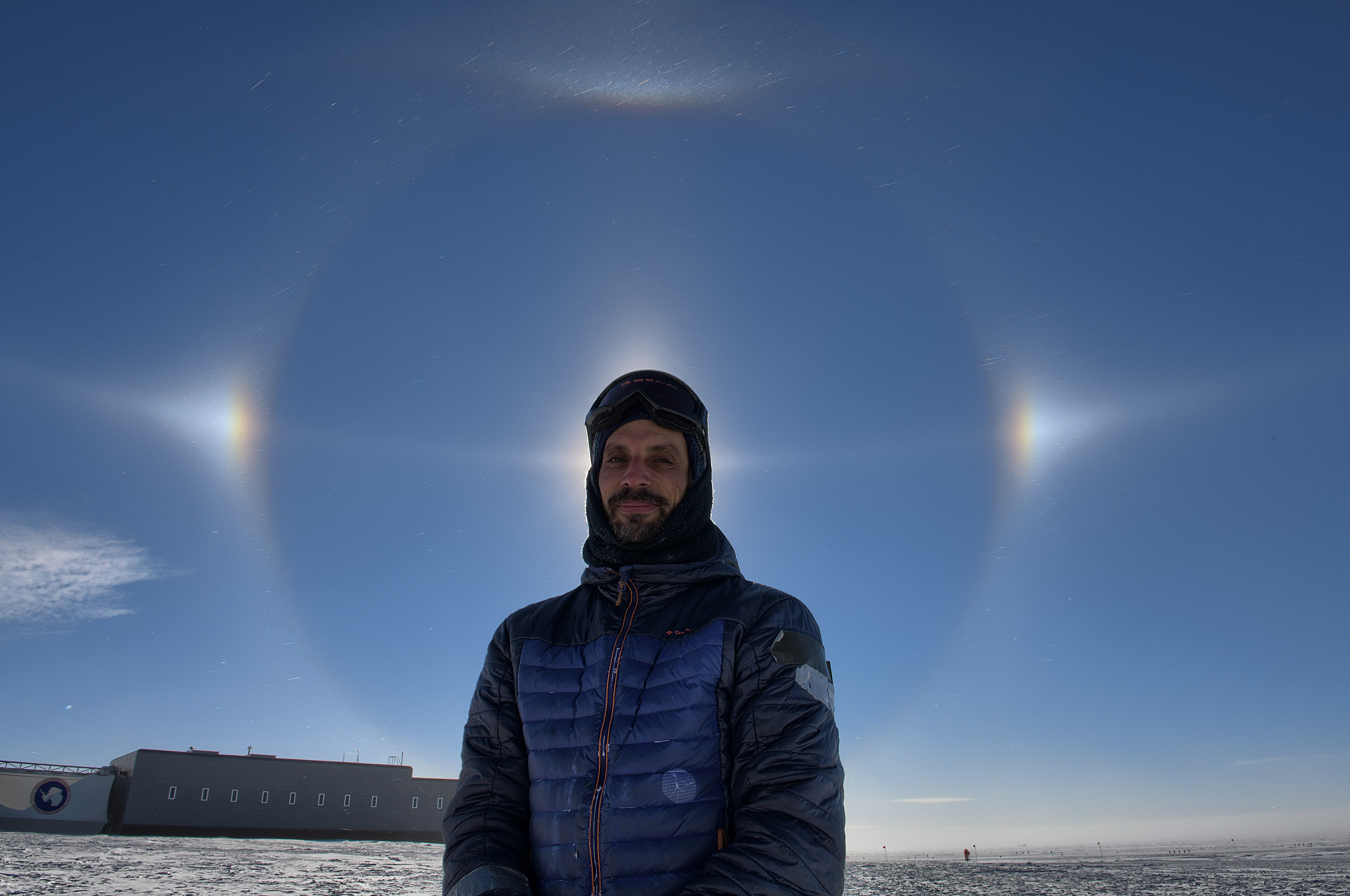 Denis Barkats stands in front of a sundog.