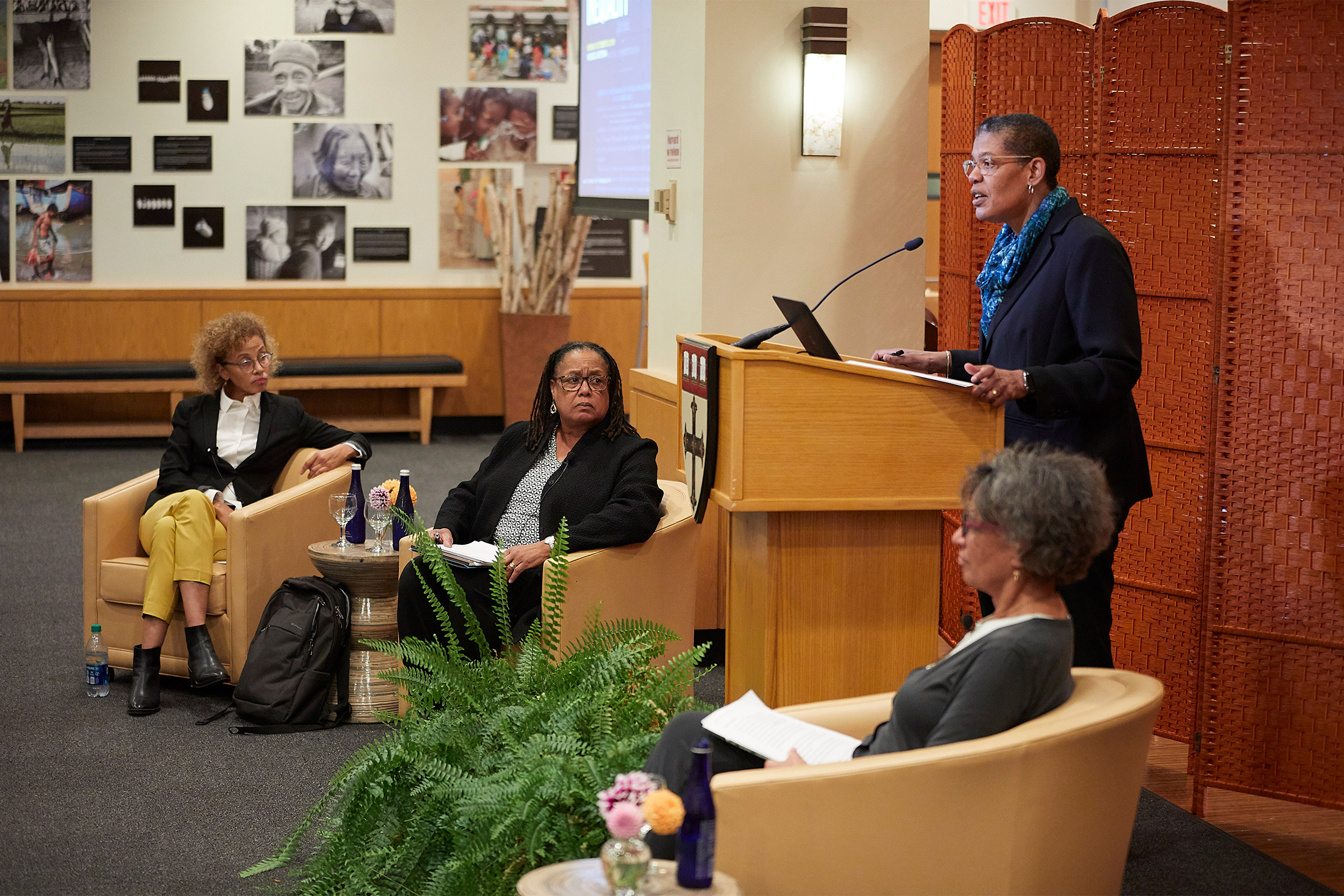 Harvard Chan School Dean Michelle A. Williams (podium) addressed the audience at the “400 Years of Inequality" event. Linda Villarosa (from left), Evelynn M. Hammonds, and Mary Bassett shared in the discussion.