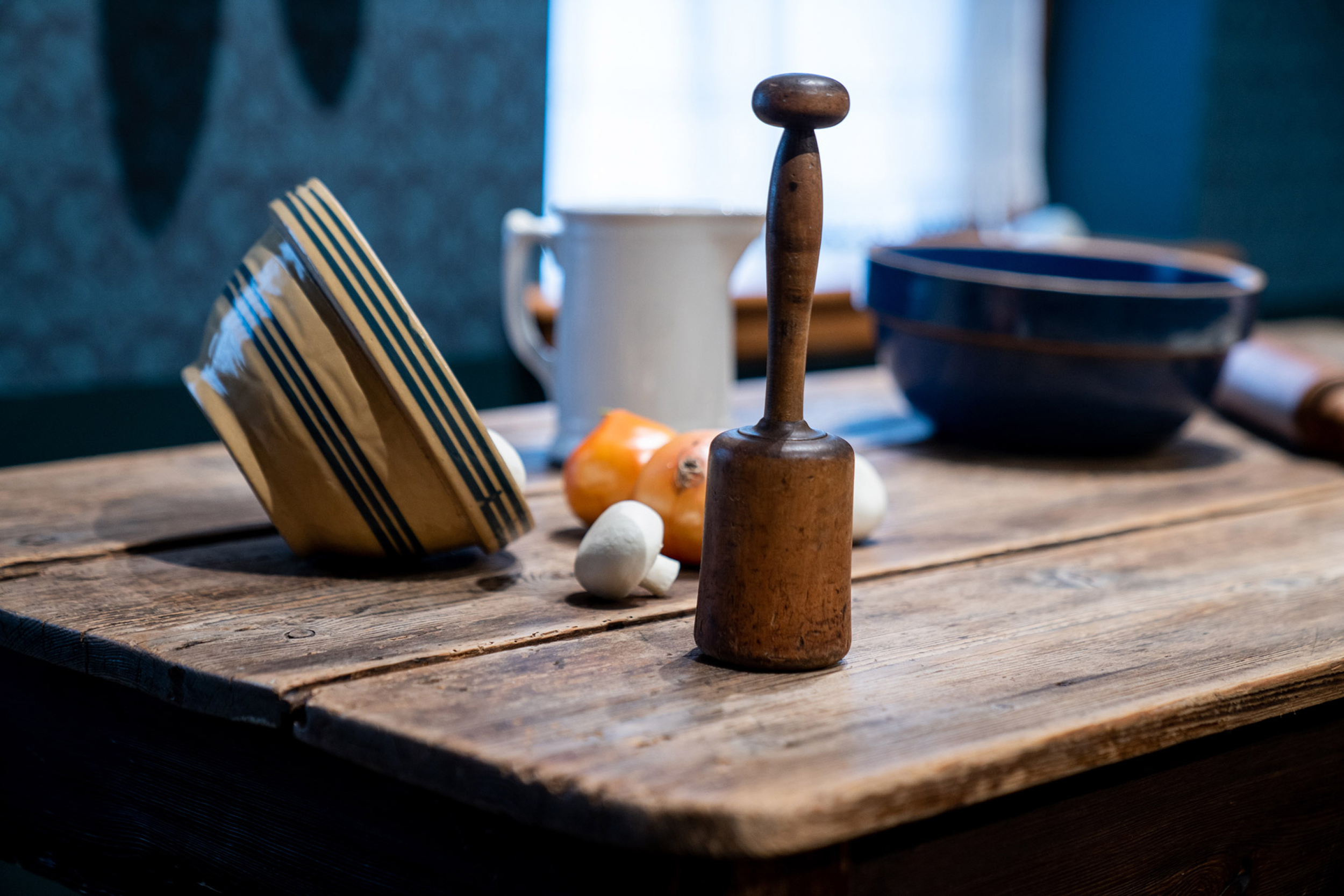 A masher for potatoes and dried goods on a table