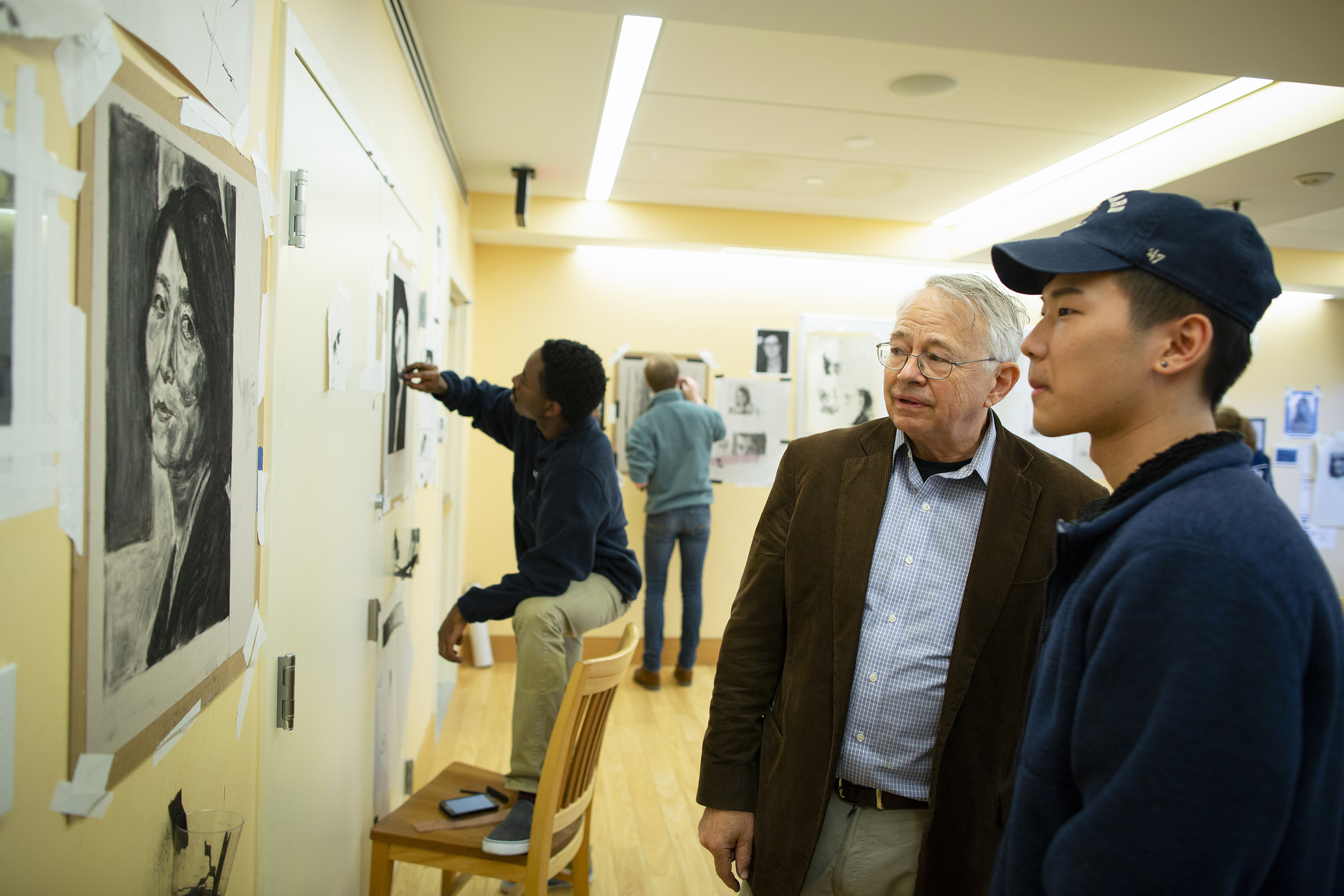 Stephen Coit and student Jang Lee examine the portrait of Lee's mother together.