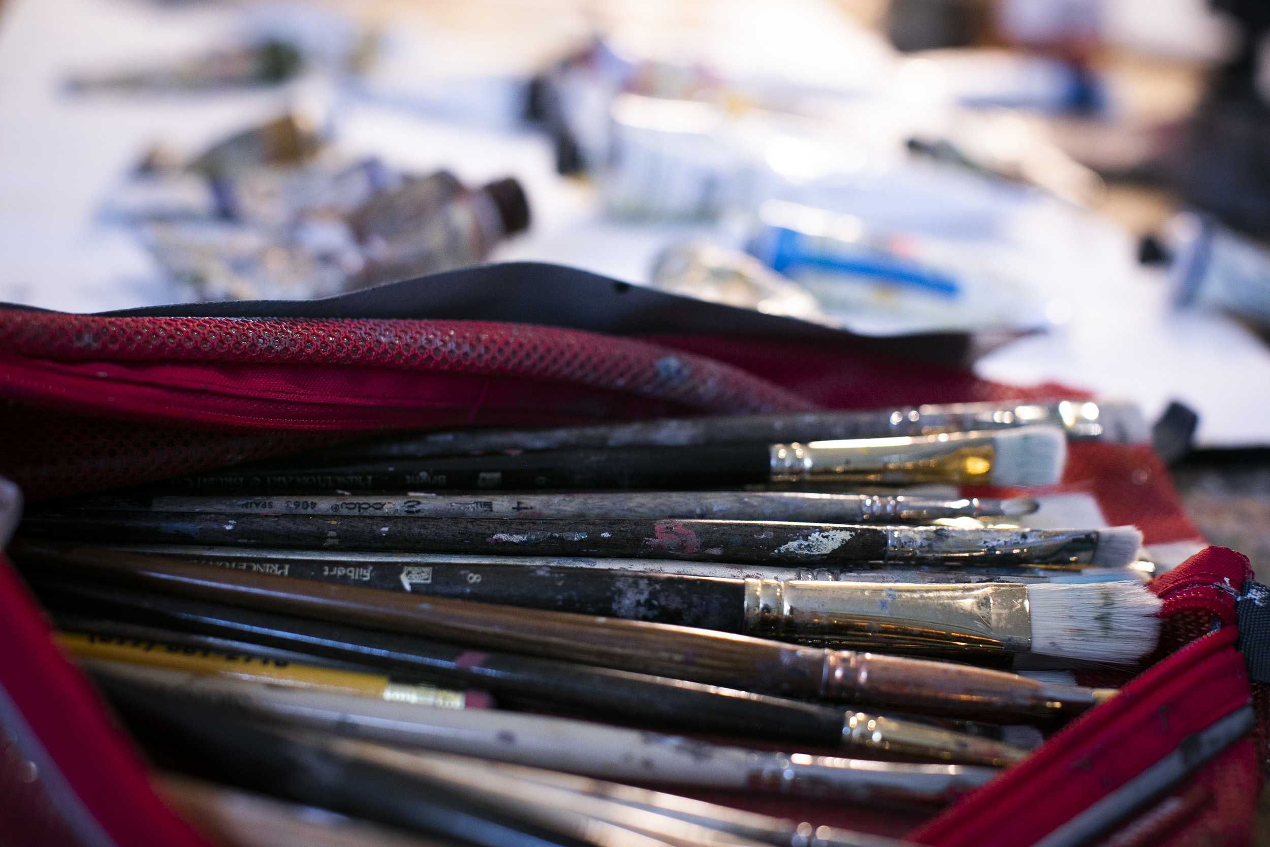 Weathered paint brushes are pictured up close.