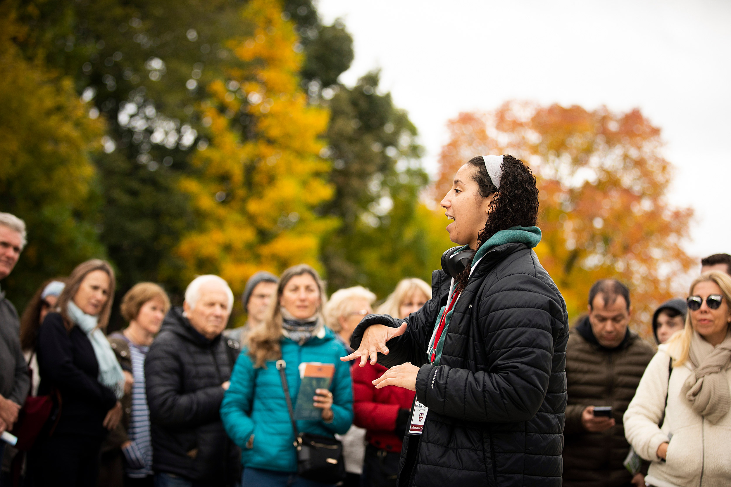 Tourists surround guide Rachel Gilchrist at Harvard's Science Center Plaza.