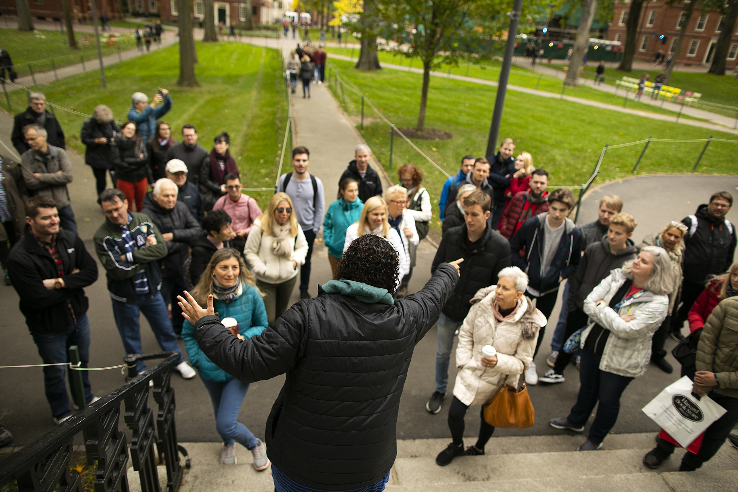 Rachel Gilchrist faces tour group in Harvard Yard.