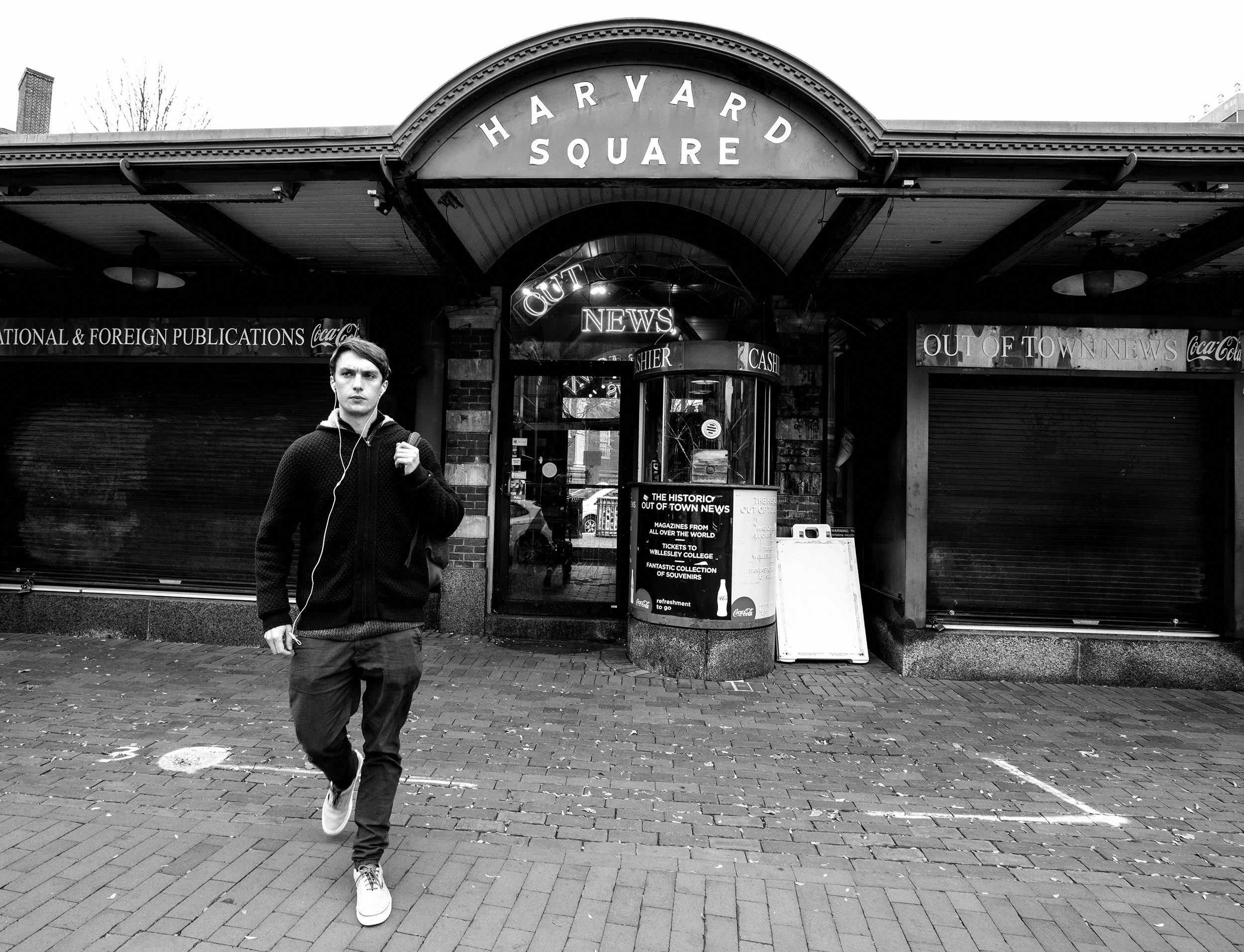 A passerby in front of the shuttered Out of Town News.