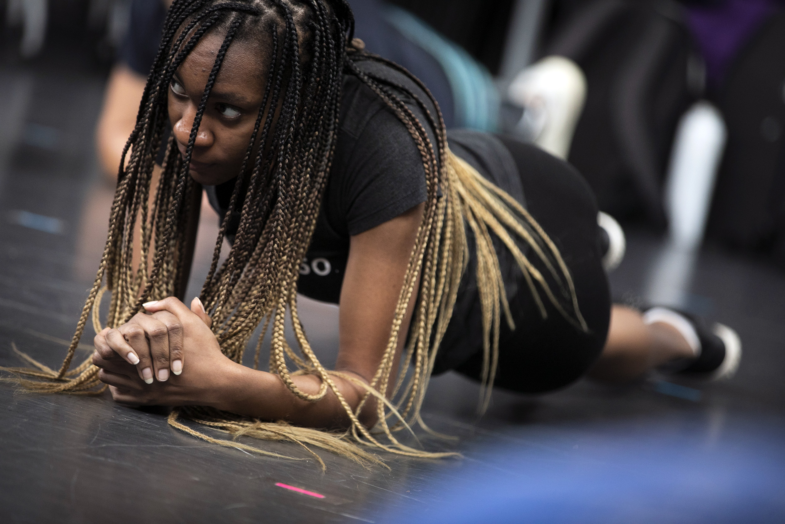 Jordan Lawanson holds a plank pose during class.