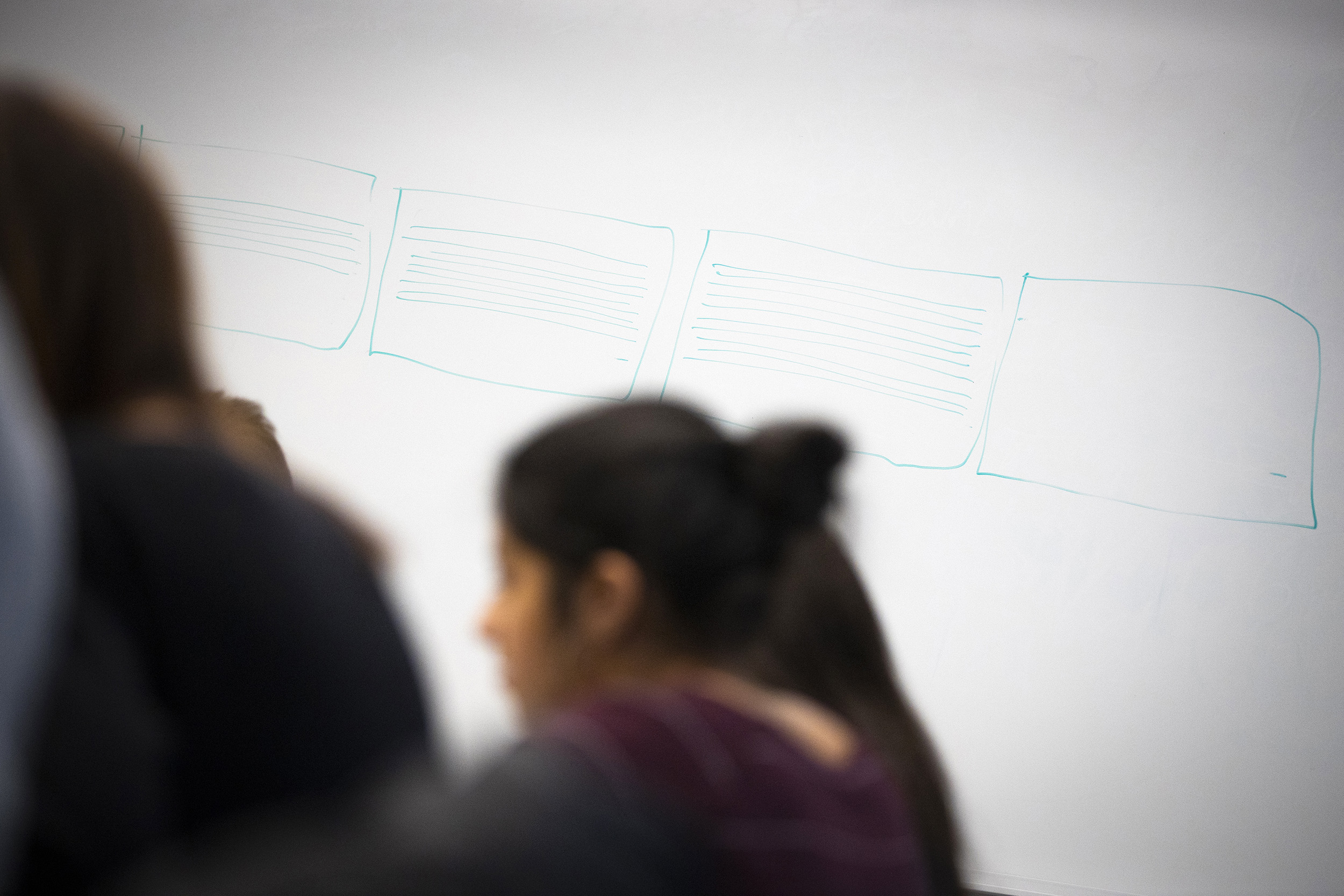 White boards show drawings of the written page.