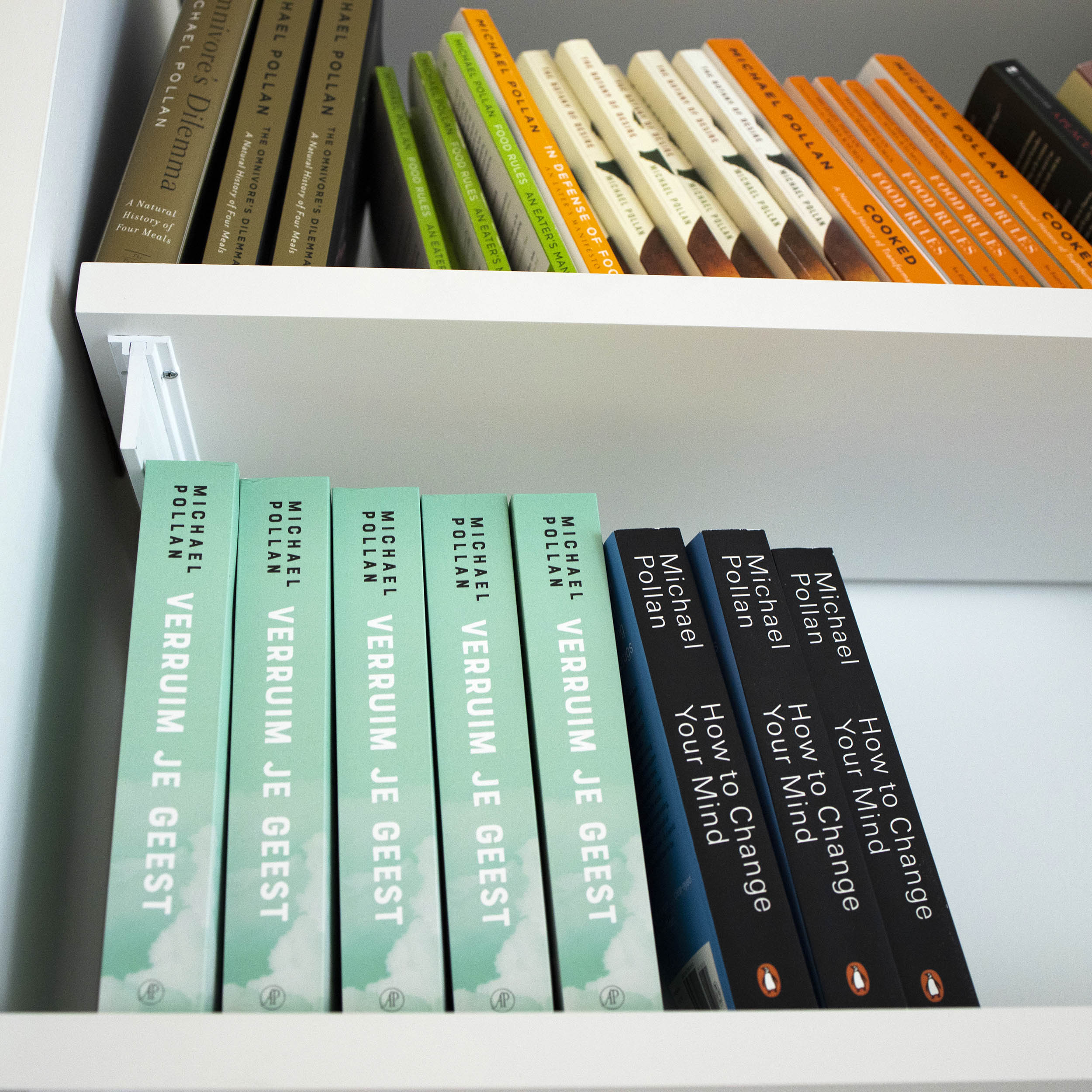 Books line a shelf in Michael Pollan's office.