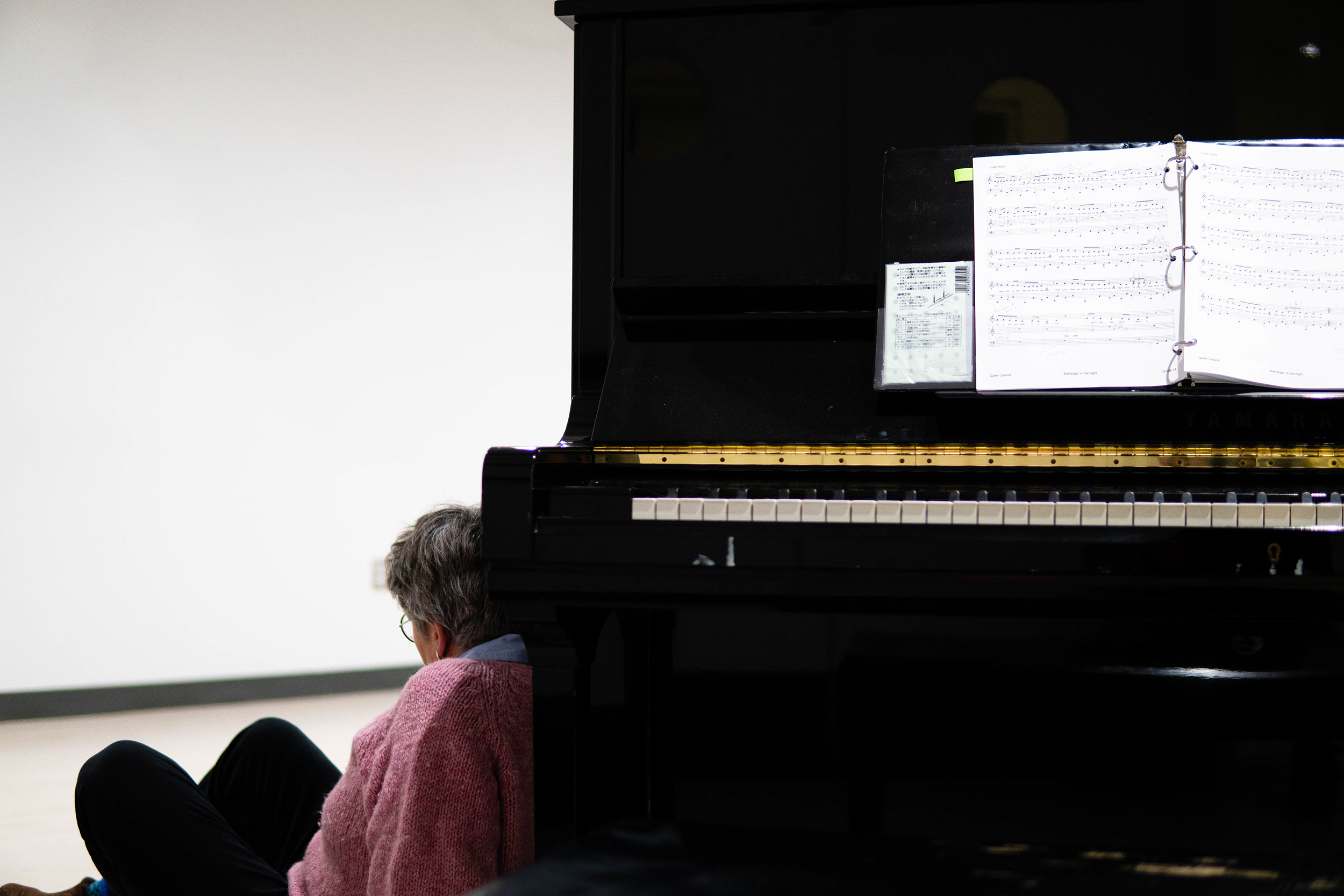 Catherine Stornetta rests behind the piano.