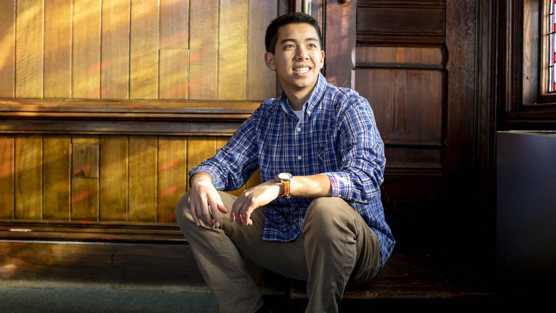 Jason sitting in a wooden room with the sun streaming in