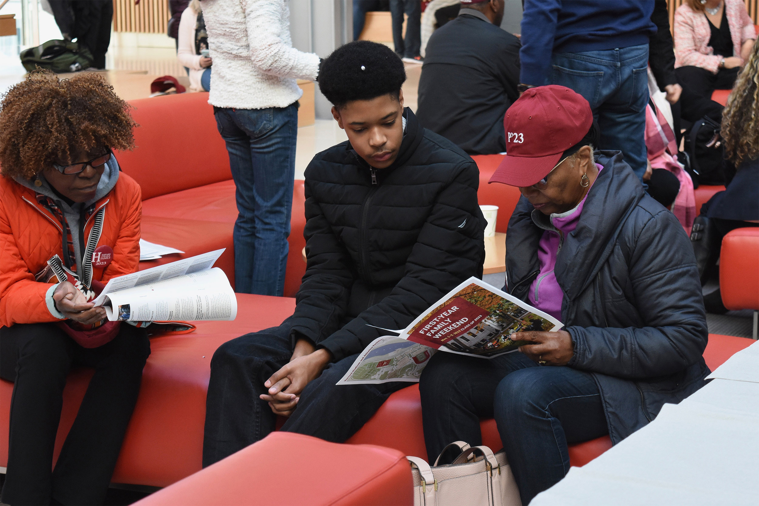 Student with family members looking at a program.