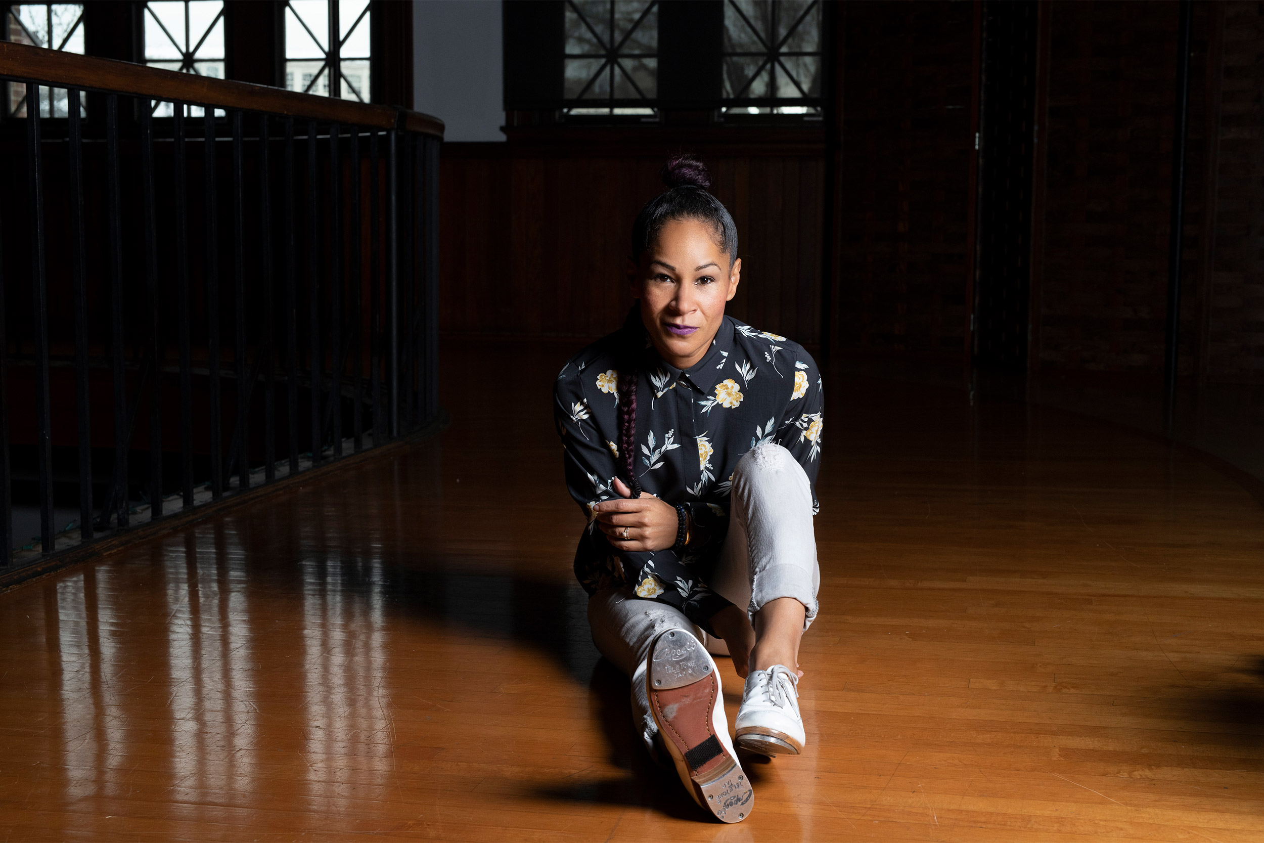 Ayodele Casel sitting on floor.