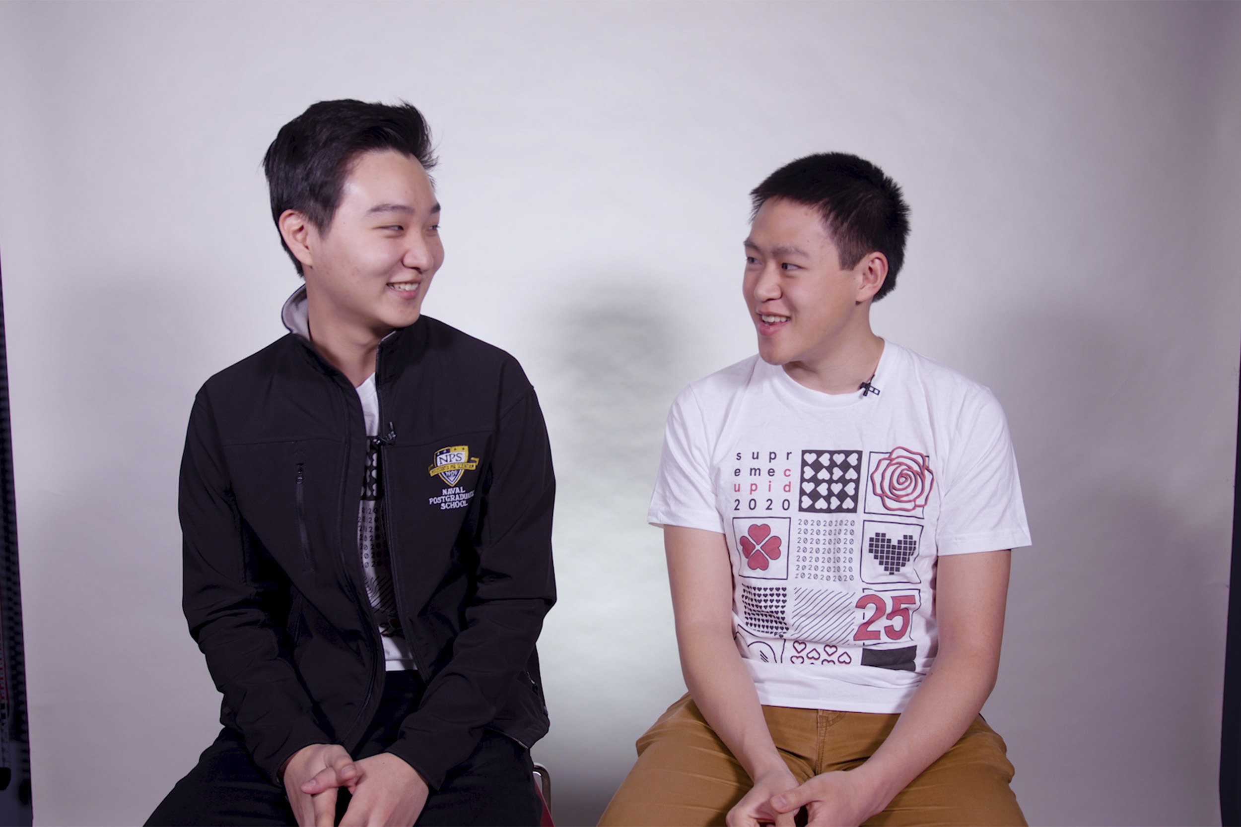 Two men sitting on stools.