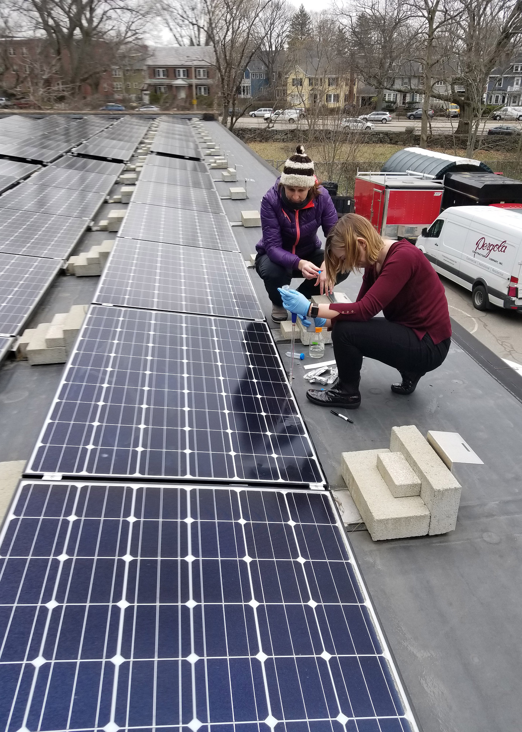 Researchers getting samples off solar panels.