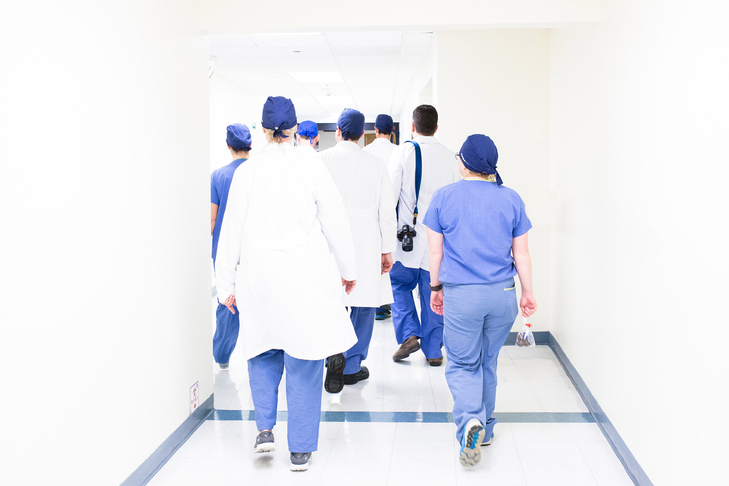 Doctors and nurses walking down a corridor.