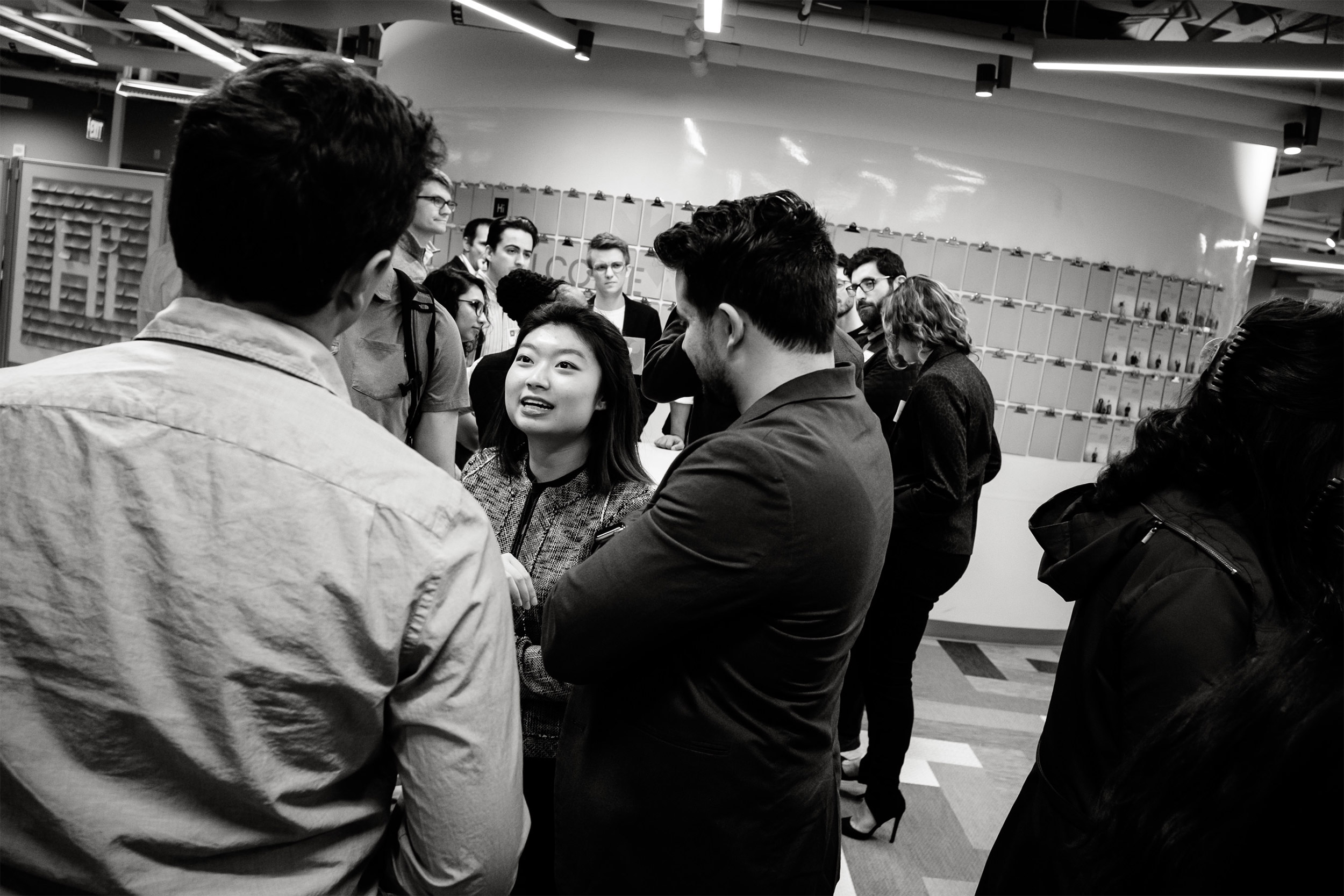 Woman speaking to two men.